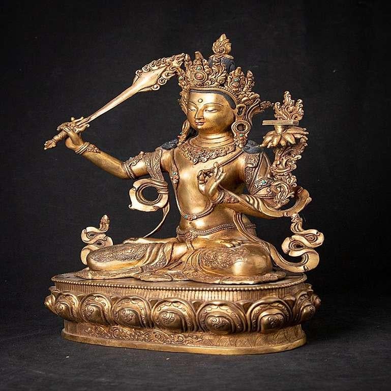 Material: bronze
41 cm high 
29,3 cm wide and 20,2 cm deep
Weight: 7.85 kgs
Fire gilded with 24 krt gold
Originating from Nepal
Middle 20th century
With inlayed gem stones
Very high quality!.
 