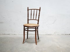 Chaise Bistro en bois de canne ancienne par Fischel Editions