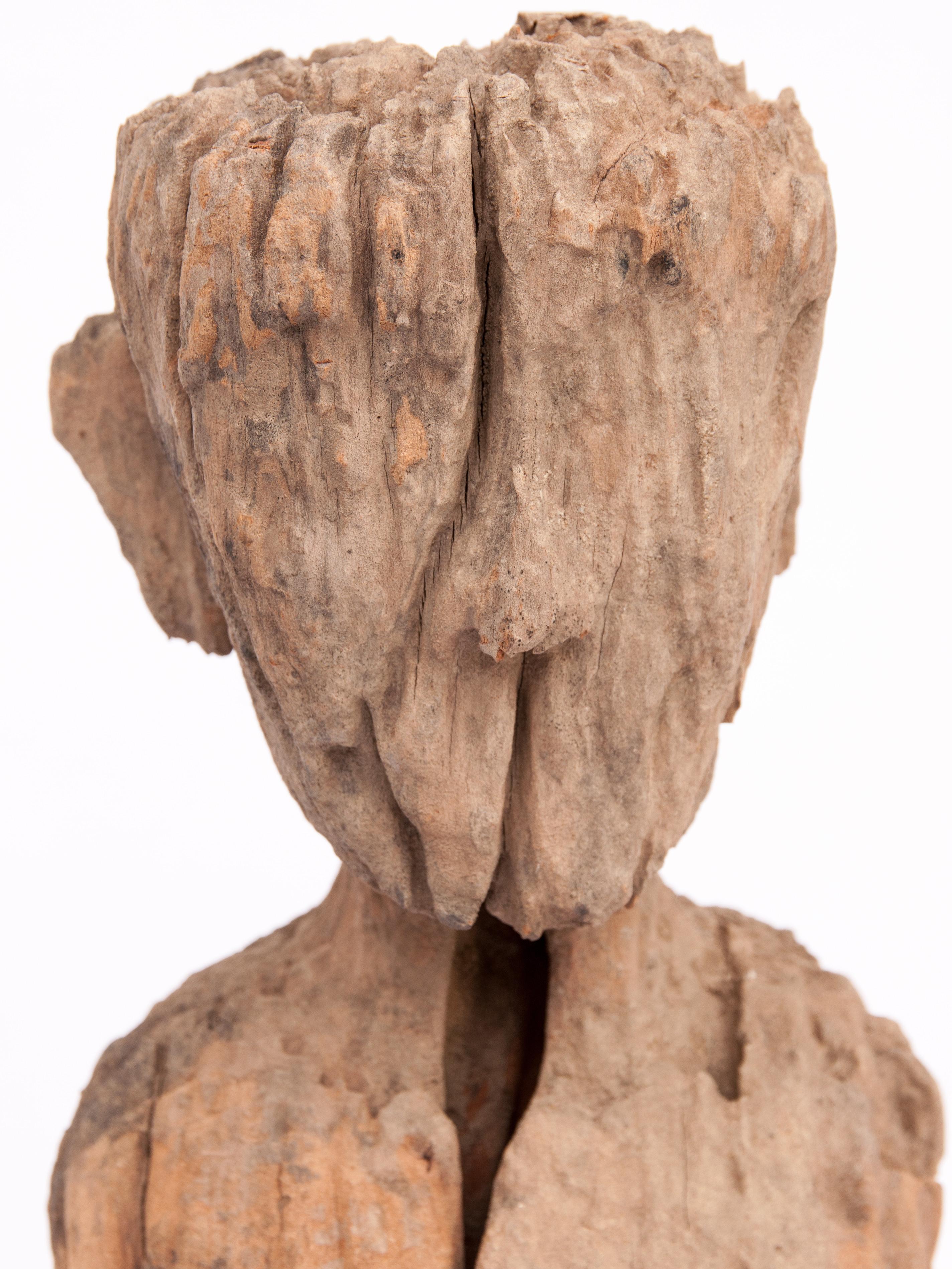 Old carved wooden figure from South or Southwest China, early 20th century. Mounted on a metal stand.
The specific origin or cultural context of this wonderfully eroded piece is unknown. It originates from south or southwest China, a vast area home