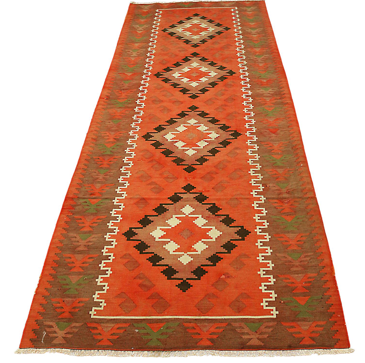 This is a semi-antique Caucasian Karabagh kilim runner woven during the second quarter of the 20th century circa 1940 and measures 288 x 102 CM in size. This piece has a highly geometric design with a center row of four repeating medallions