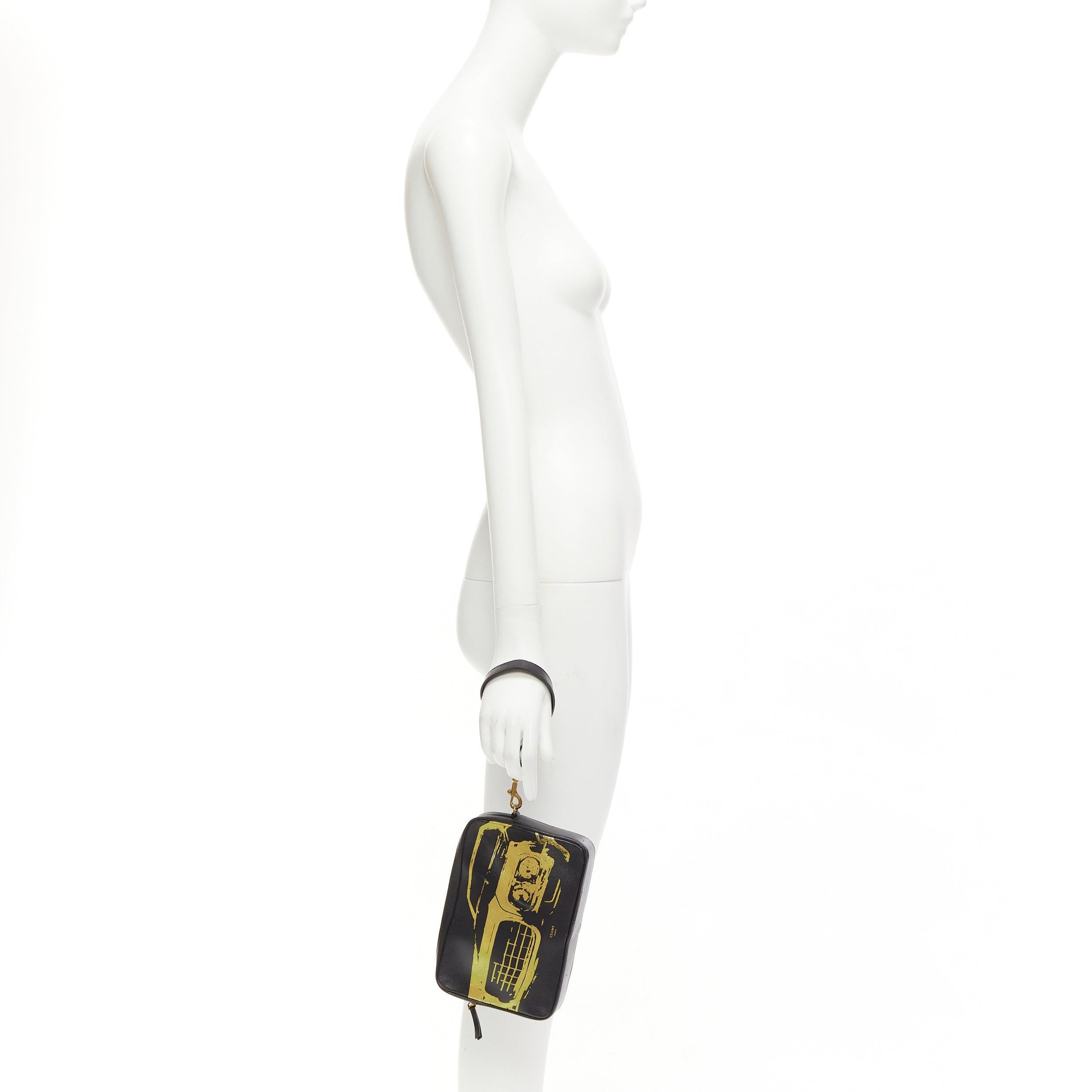 OLD CELINE Mustang Vintage Car print black leather gold foil wristlet clutch bag
Reference: LNKO/A02394
Brand: Celine
Designer: Phoebe Philo
Material: Leather
Color: Black, Gold
Pattern: Abstract
Closure: Zip
Lining: Black Leather
Extra Details: