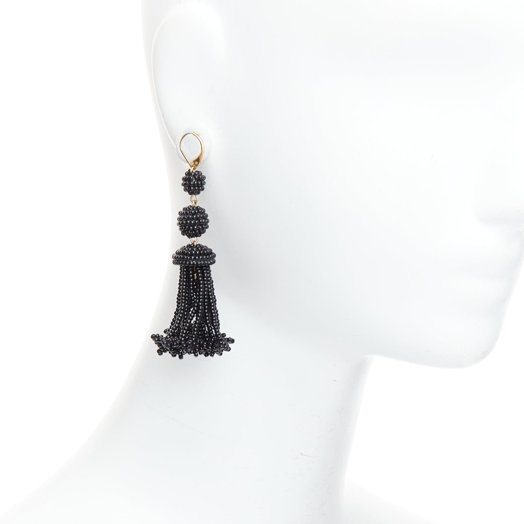 OLD CELINE Phoebe Philo black beaded tassel chandelier earrings
Reference: TGAS/E00733
Brand: Celine
Designer: Phoebe Philo
Material: Plastic
Color: Gold, Black
Pattern: Solid
Closure: Loop Through
Extra Details: Logo plate at bottom.
Made in:
