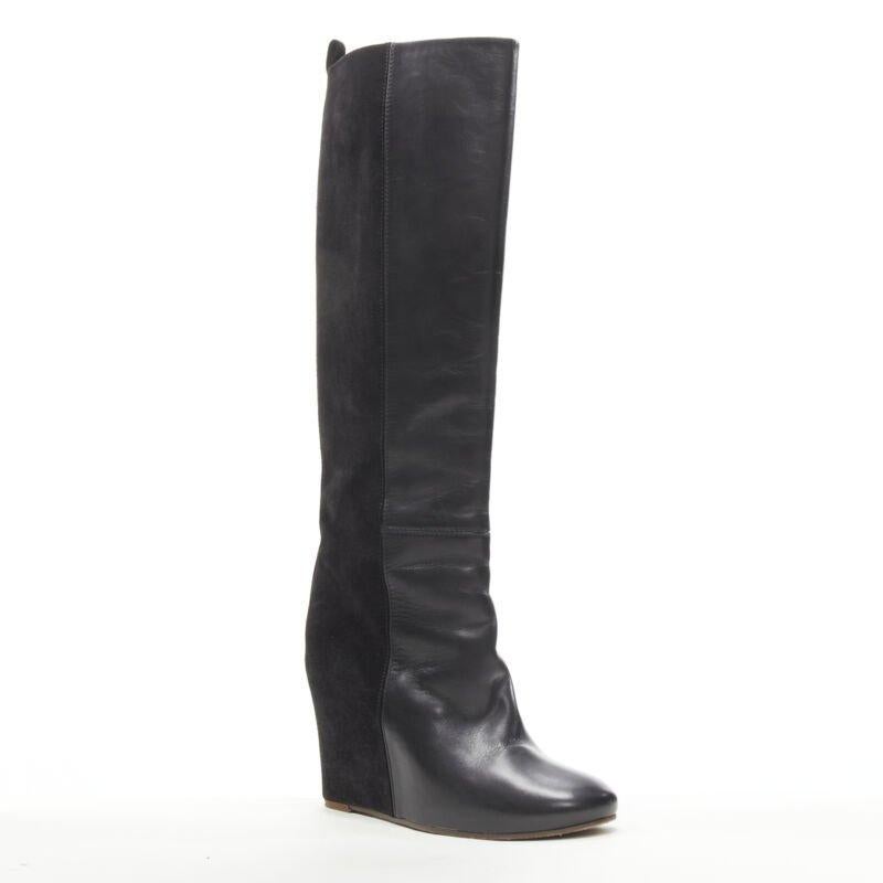 OLD CELINE Phoebe Philo black leather suede 50/50 platform wedge boot EU38
Reference: KNLM/A00244
Brand: Celine
Designer: Phoebe Philo
Material: Leather, Suede
Color: Black
Pattern: Solid
Closure: Pull On
Lining:  Leather
Extra Details: Half
