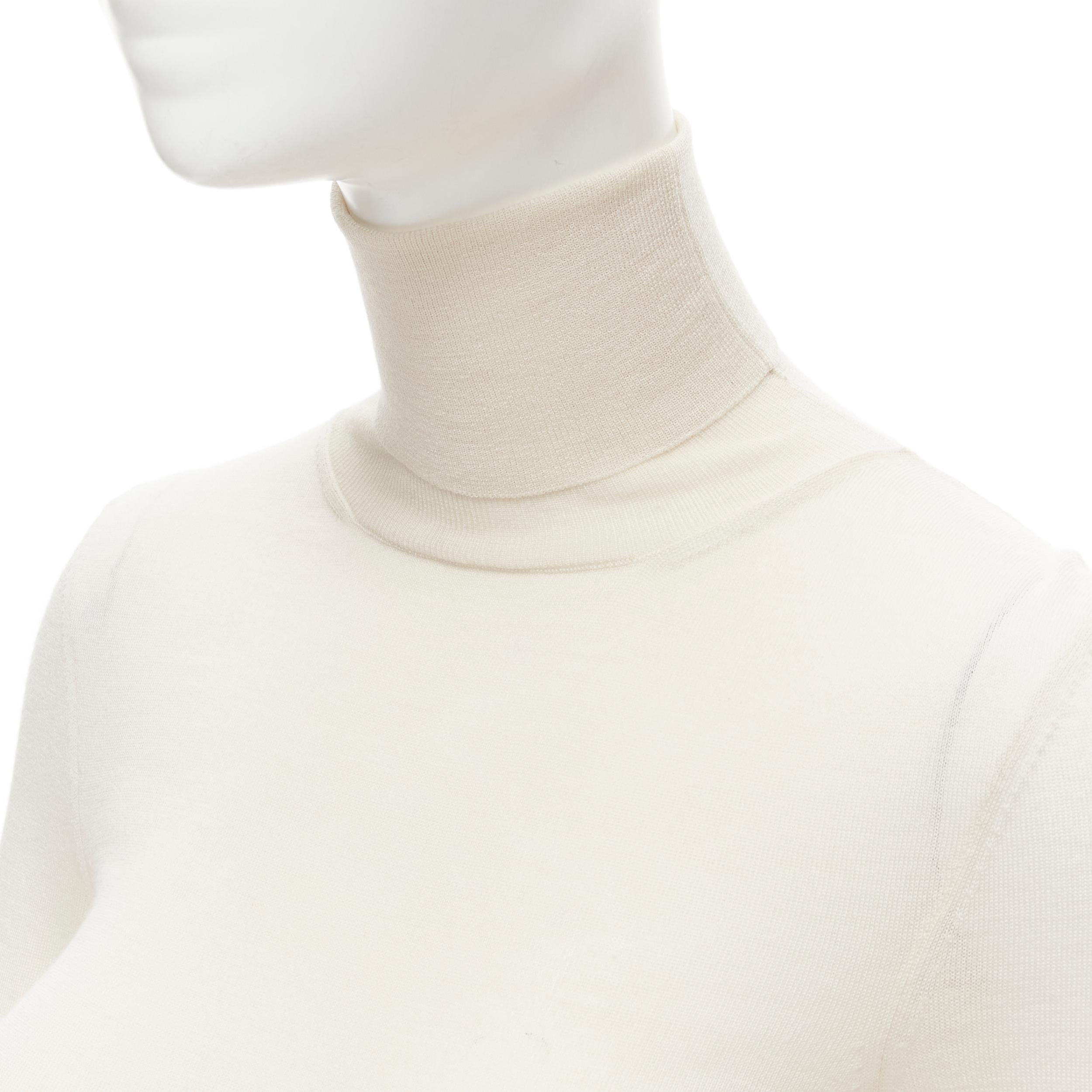 OLD CELINE Phoebe Philo cream fine knit turtleneck sweater S 
Reference: MELK/A00046 
Brand: Celine 
Designer: Phoebe Philo 
Color: Beige 
Pattern: Solid 

CONDITION: 
Condition: Very good, this item was pre-owned and is in very good condition.
