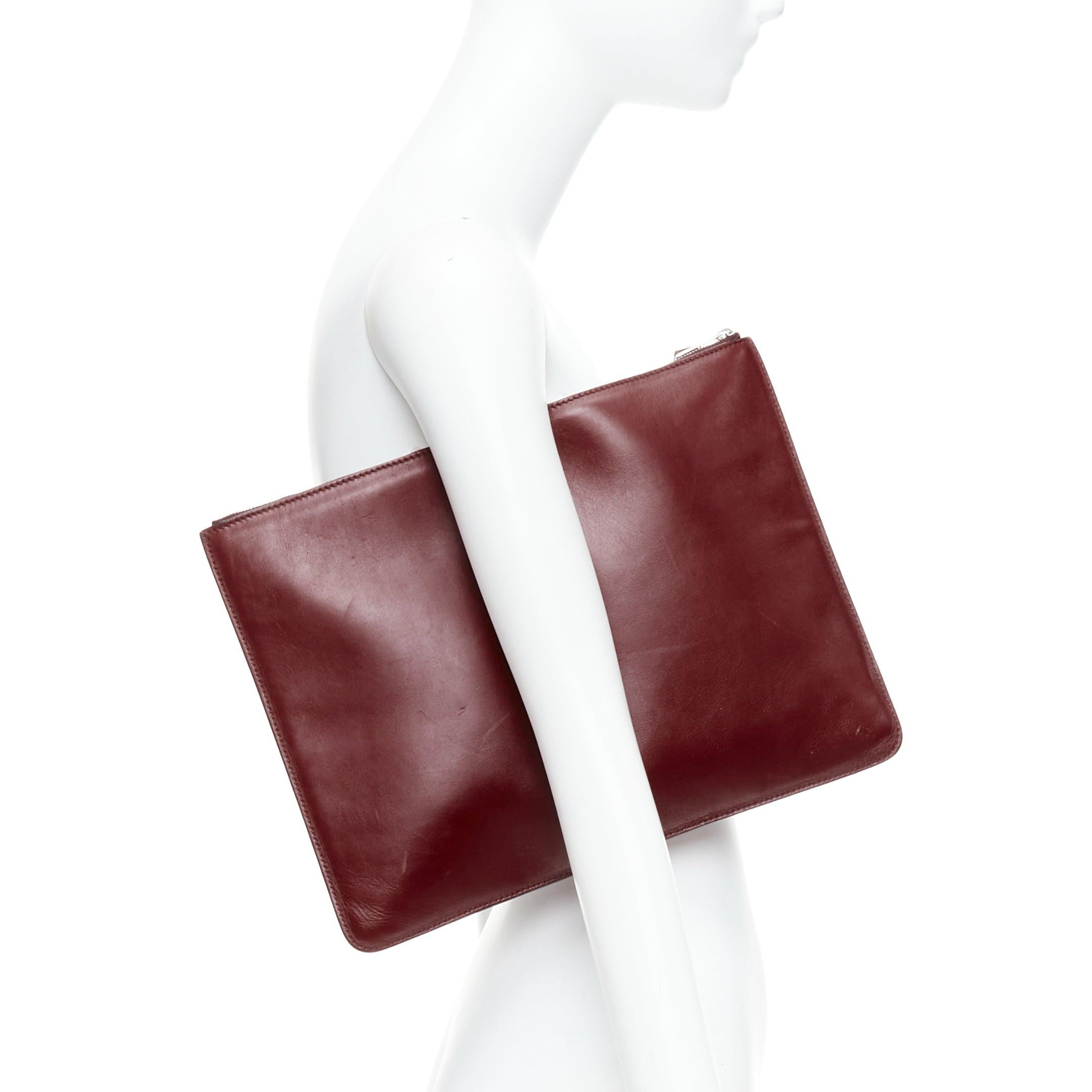 OLD CELINE Phoebe Philo Portfolio burgundy silver metal trim zip clutch
Reference: ALCU/A00033
Brand: Celine
Designer: Phoebe Philo
Material: Leather
Color: Burgundy
Pattern: Solid
Closure: Zip
Lining: Black Leather
Extra Details: Zip and push clasp