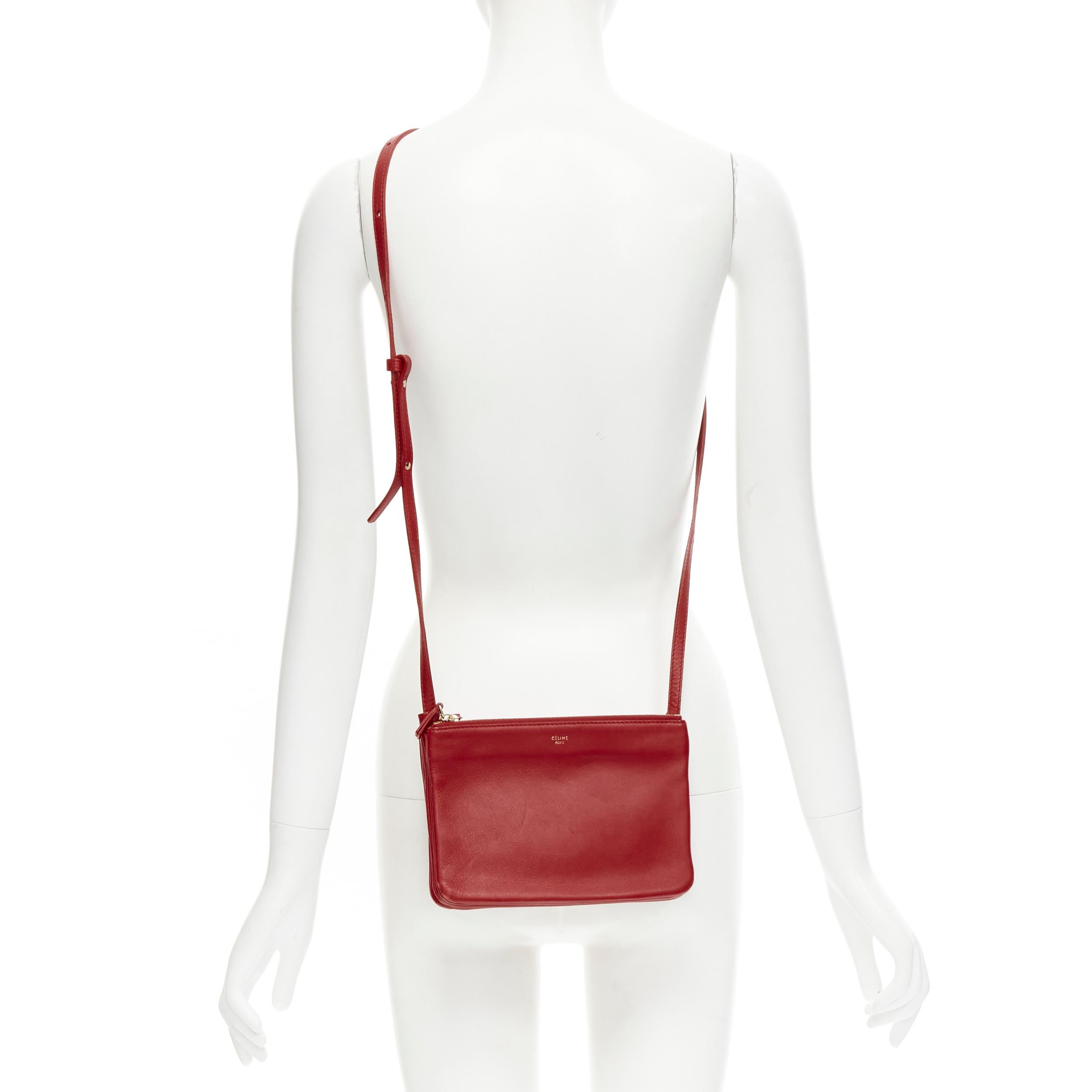 OLD CELINE Phoebe Philo red leather snap pocket Trio Pouch zip crossbody 
Reference: JNWG/A00020 
Brand: Celine 
Designer: Phoebe Philo 
Model: Trio 
Material: Leather 
Color: Red 
Pattern: Solid 
Closure: Zip 
Extra Detail: Trio pouch crossbody.