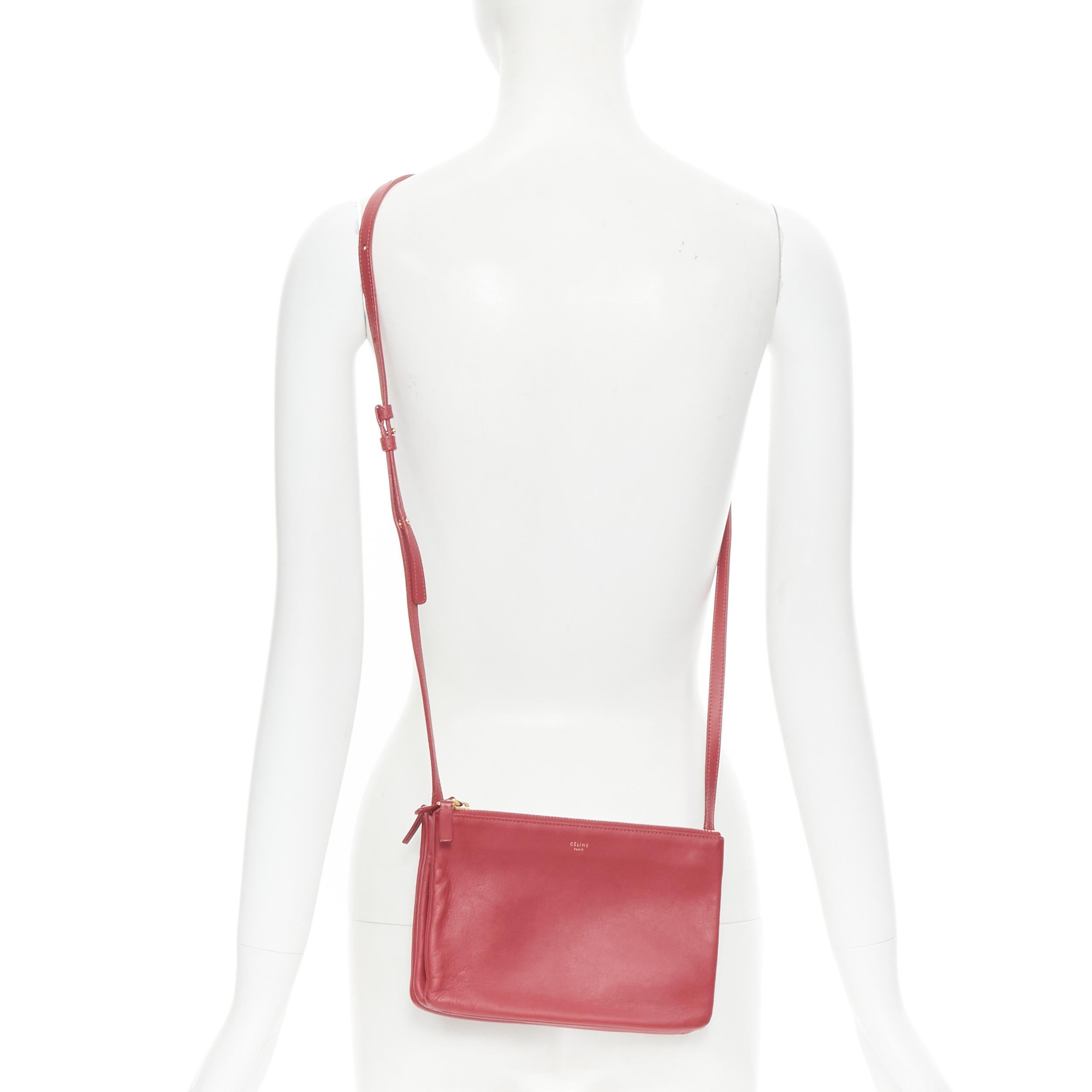 OLD CELINE Phoebe Philo Trio red gold zip triple snap pouch crossbody bag 
Reference: TALI/A00003 
Brand: Celine 
Designer: Phoebe Philo 
Model: Trio crossbody 
Material: Leather 
Color: Red 
Pattern: Solid 
Closure: Zip 
Extra Detail: Trio