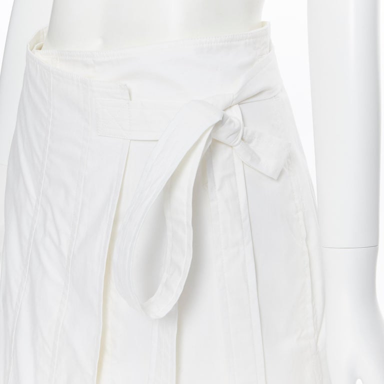 OLD CELINE PHOEBE PHILO white cotton wrap self tie darted midi skirt XS
Brand: Celine
Designer: Phoebe Philo
Model Name / Style: Wrap skirt
Material: Unknown; feels like cototn
Color: White
Pattern: Solid
Closure: Tie
Extra Detail: Self tie belted