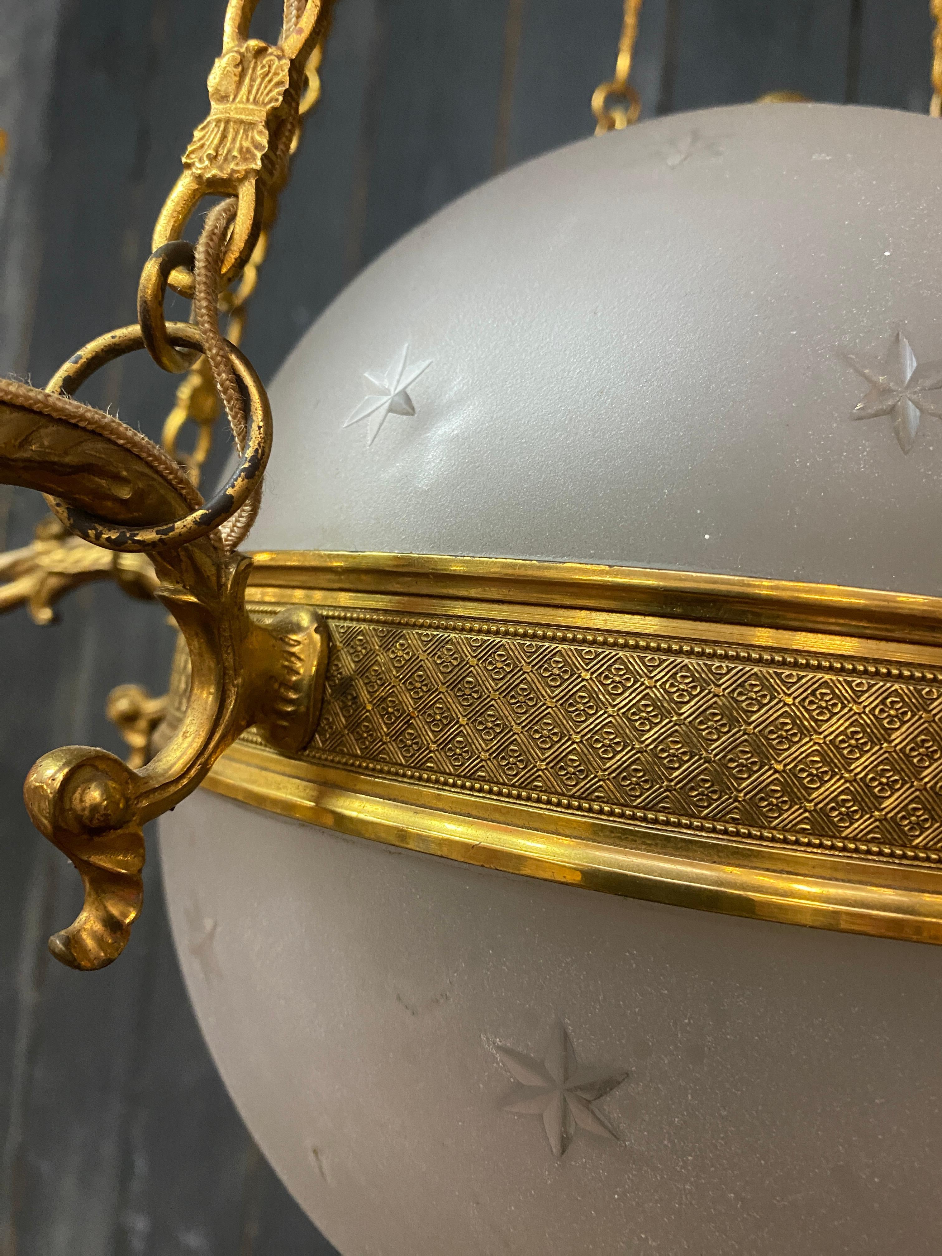 old chandelier in bronze and frosted glass decorated with engraved stars.  For Sale 2