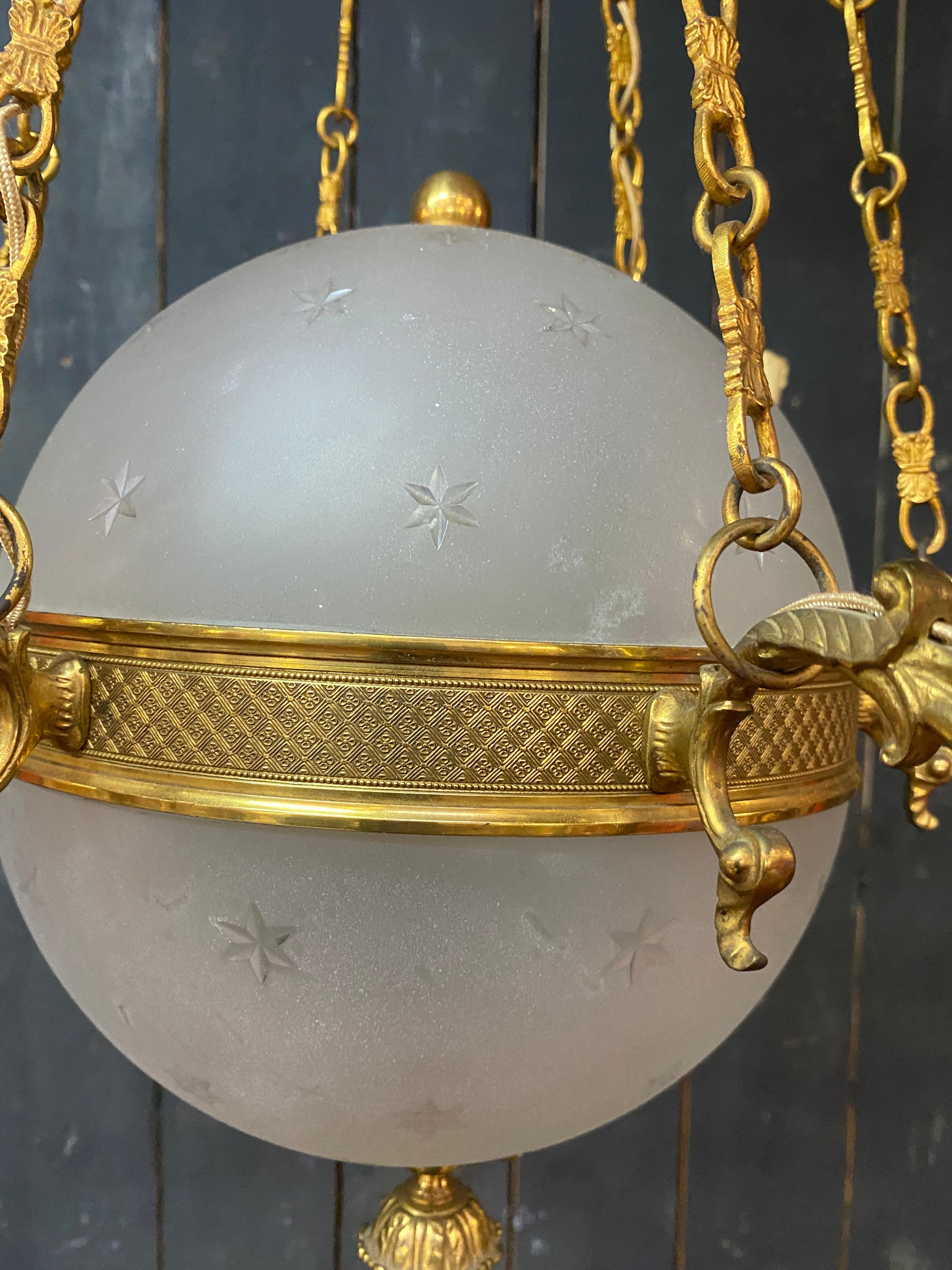 old chandelier in bronze and frosted glass decorated with engraved stars.  For Sale 11