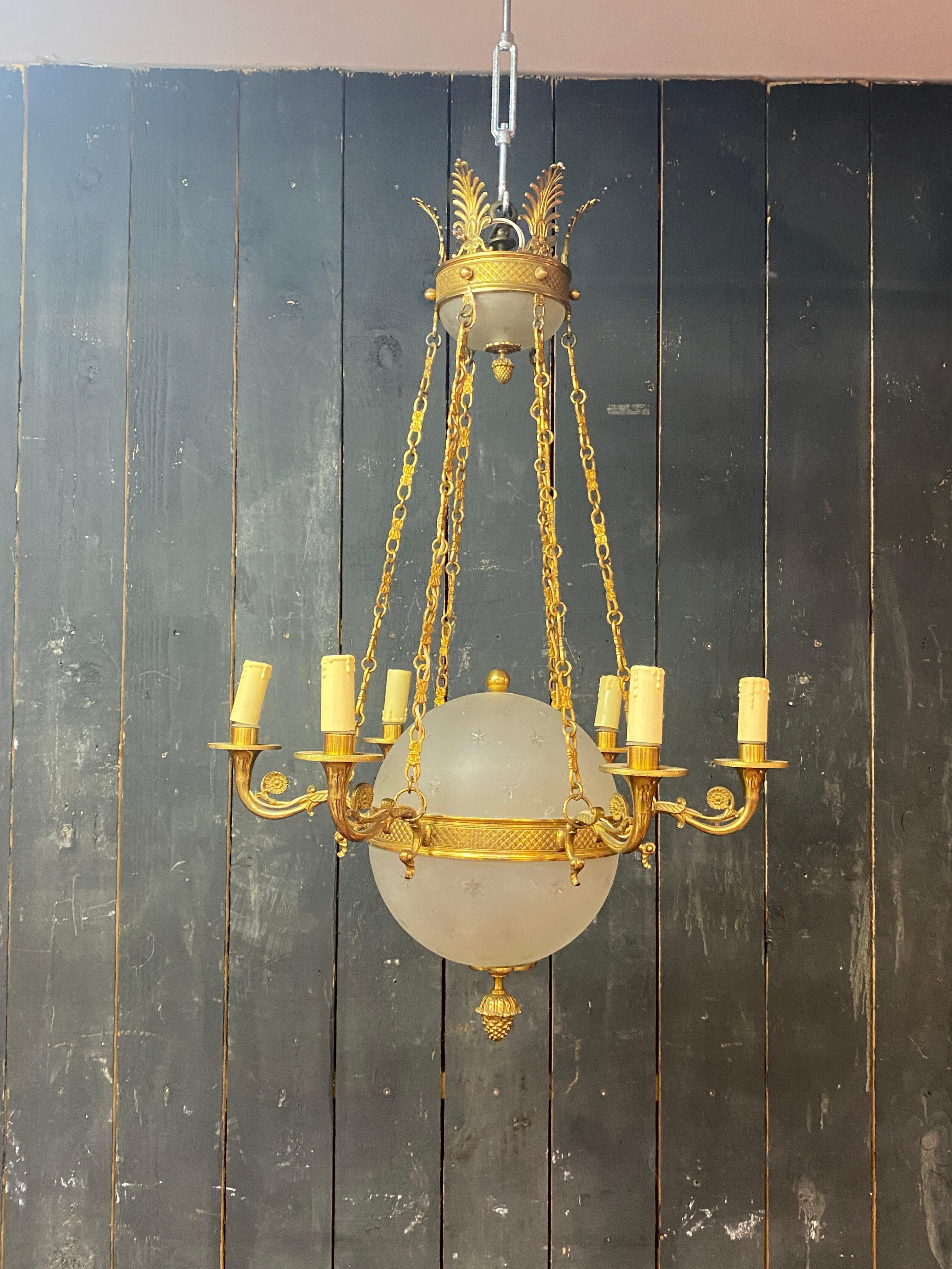 old chandelier in bronze and frosted glass decorated with engraved stars.
Very good quality
