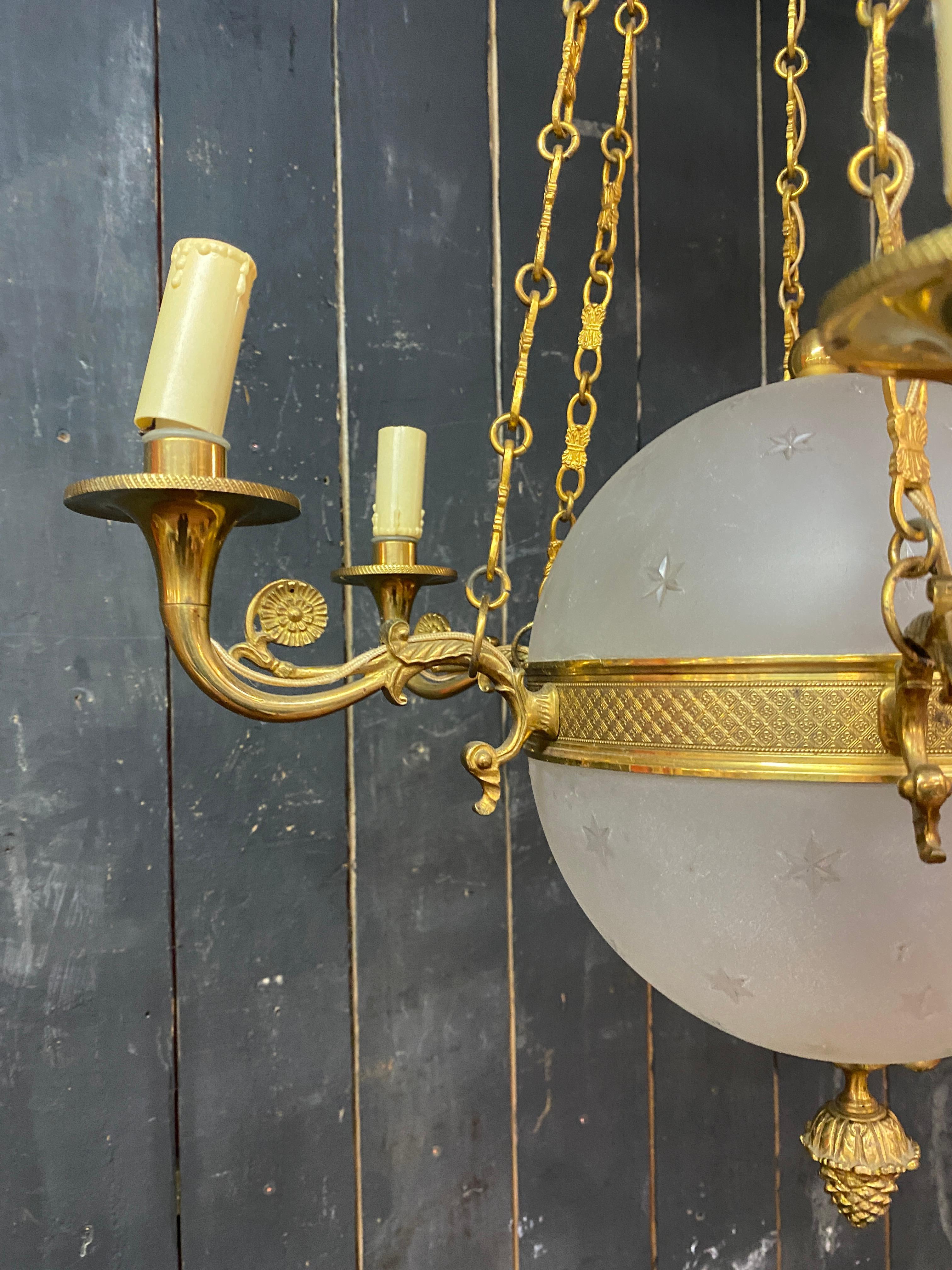 French old chandelier in bronze and frosted glass decorated with engraved stars.  For Sale