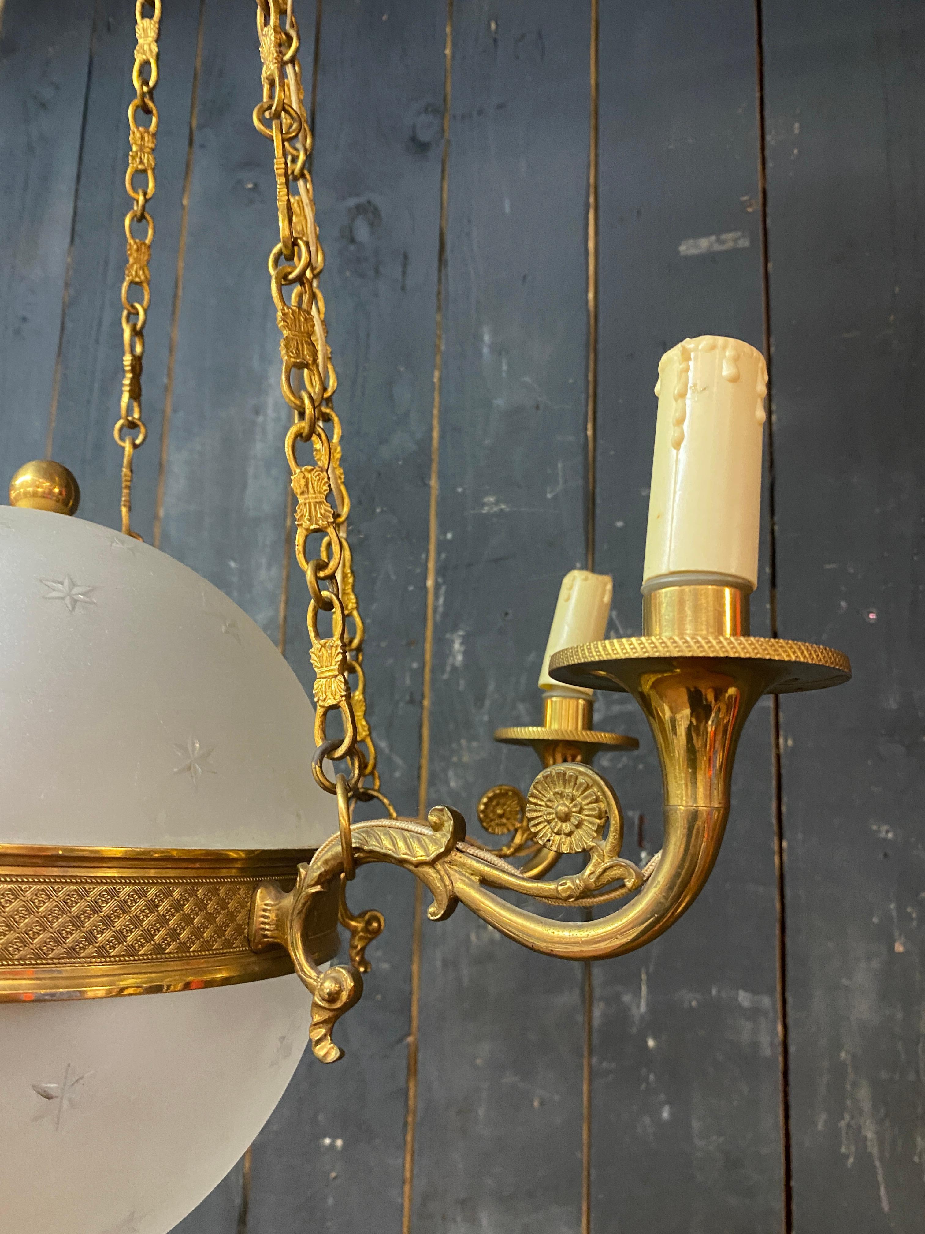 Frosted old chandelier in bronze and frosted glass decorated with engraved stars.  For Sale