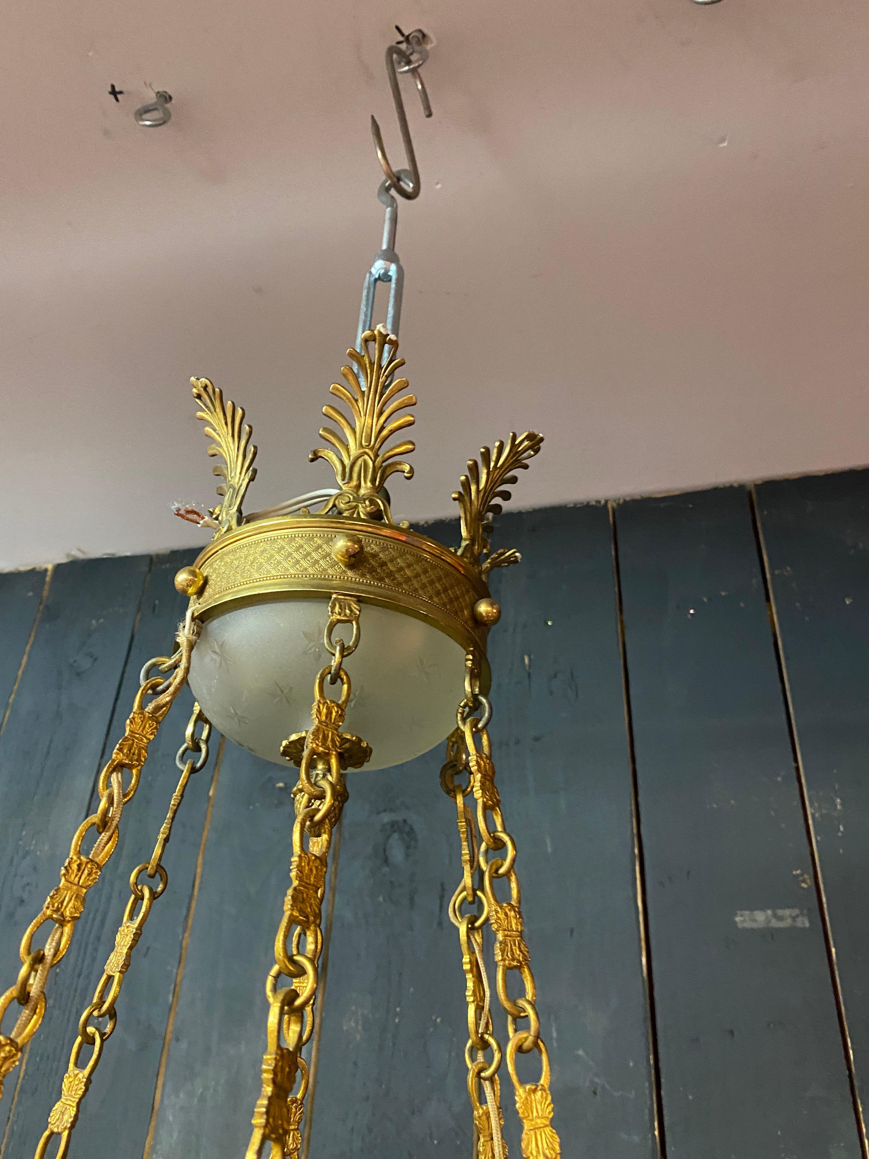 old chandelier in bronze and frosted glass decorated with engraved stars.  In Good Condition For Sale In Saint-Ouen, FR