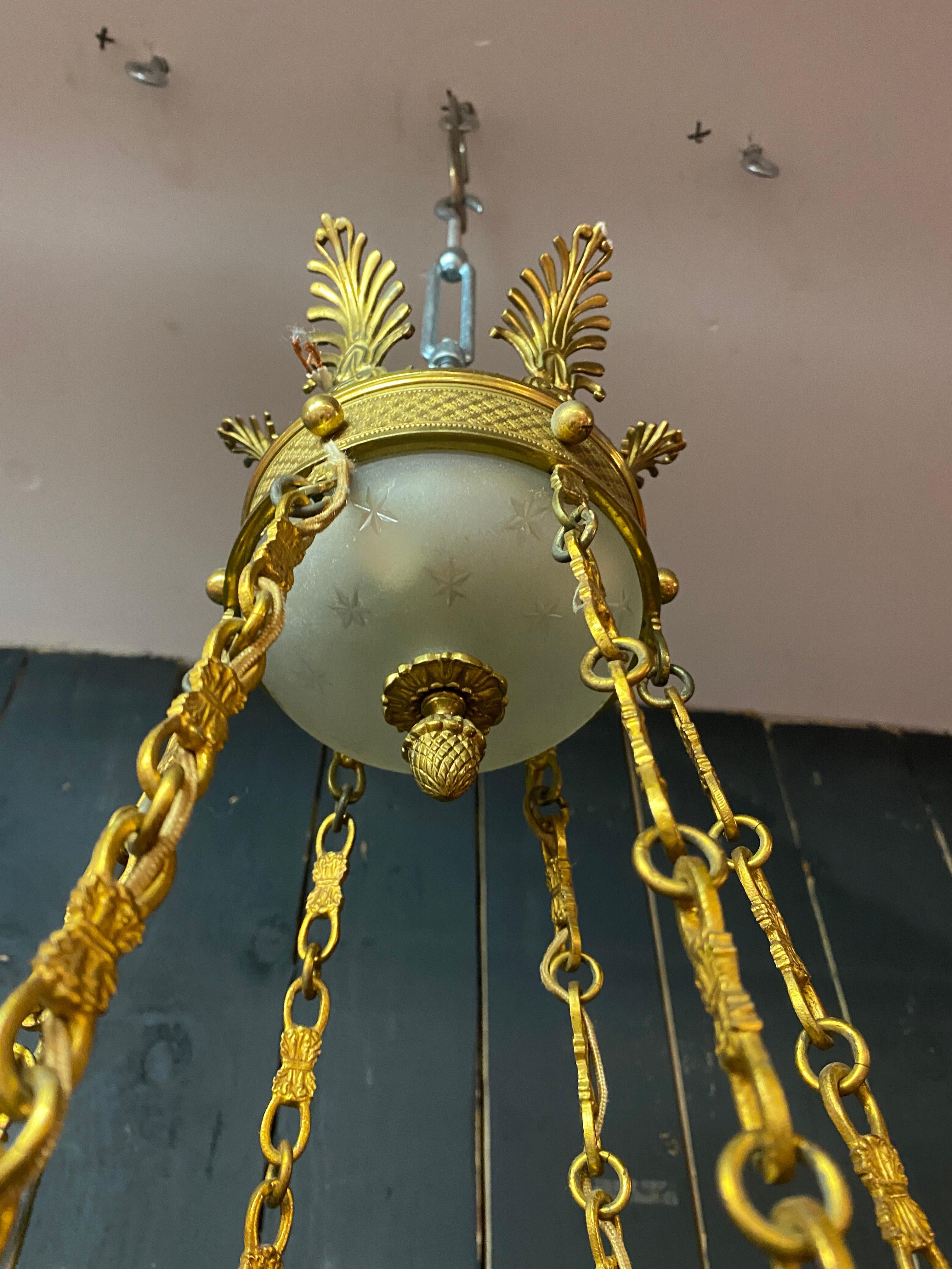 20th Century old chandelier in bronze and frosted glass decorated with engraved stars.  For Sale
