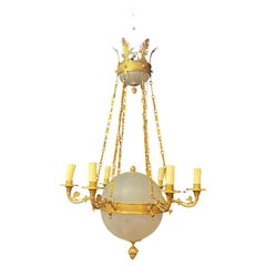 Antique old chandelier in bronze and frosted glass decorated with engraved stars. 