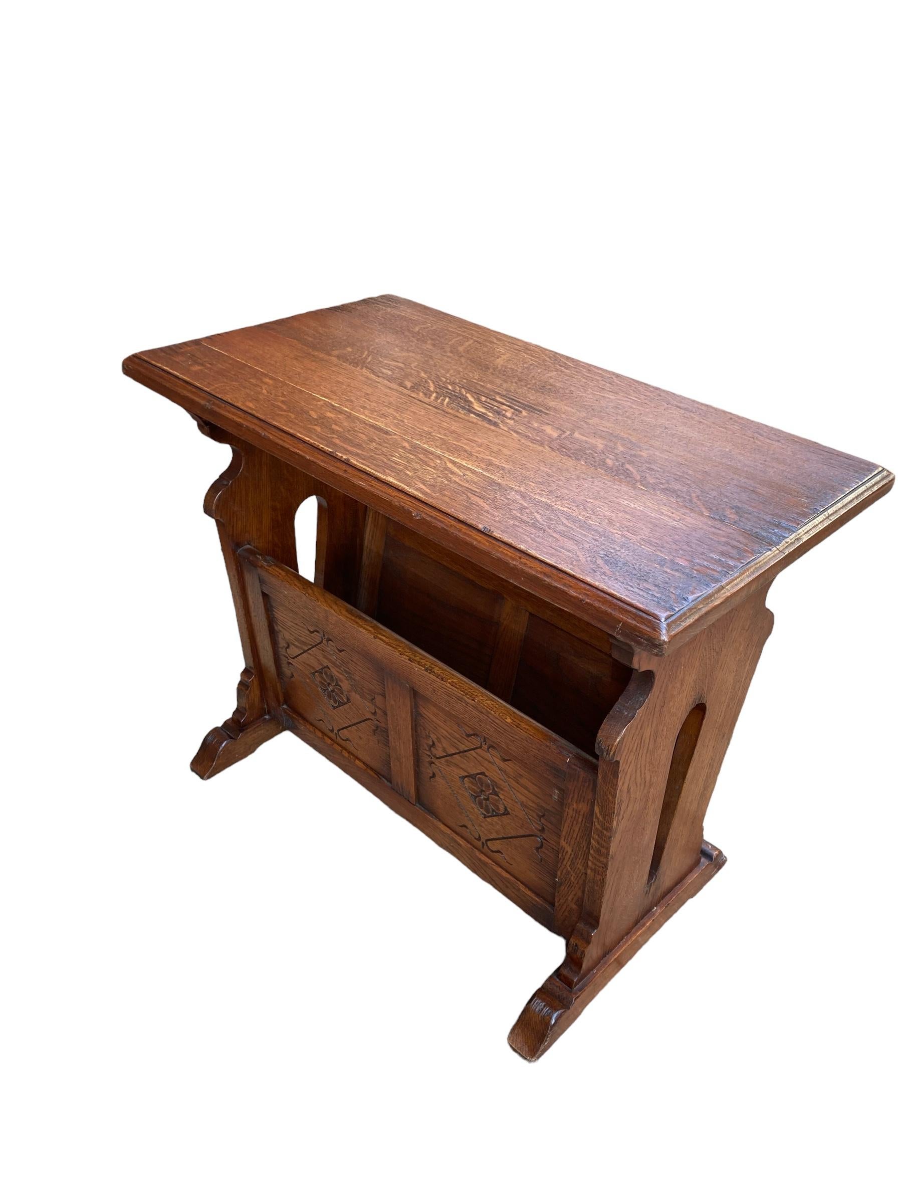 Old Charm Carved Oak small side table Magazine Rack. The tops raised on shaped ends joined with side planks with a simple carved Rose detail, which form a useful magazine or book holder as well as a handy small coffee or side table. Raised on