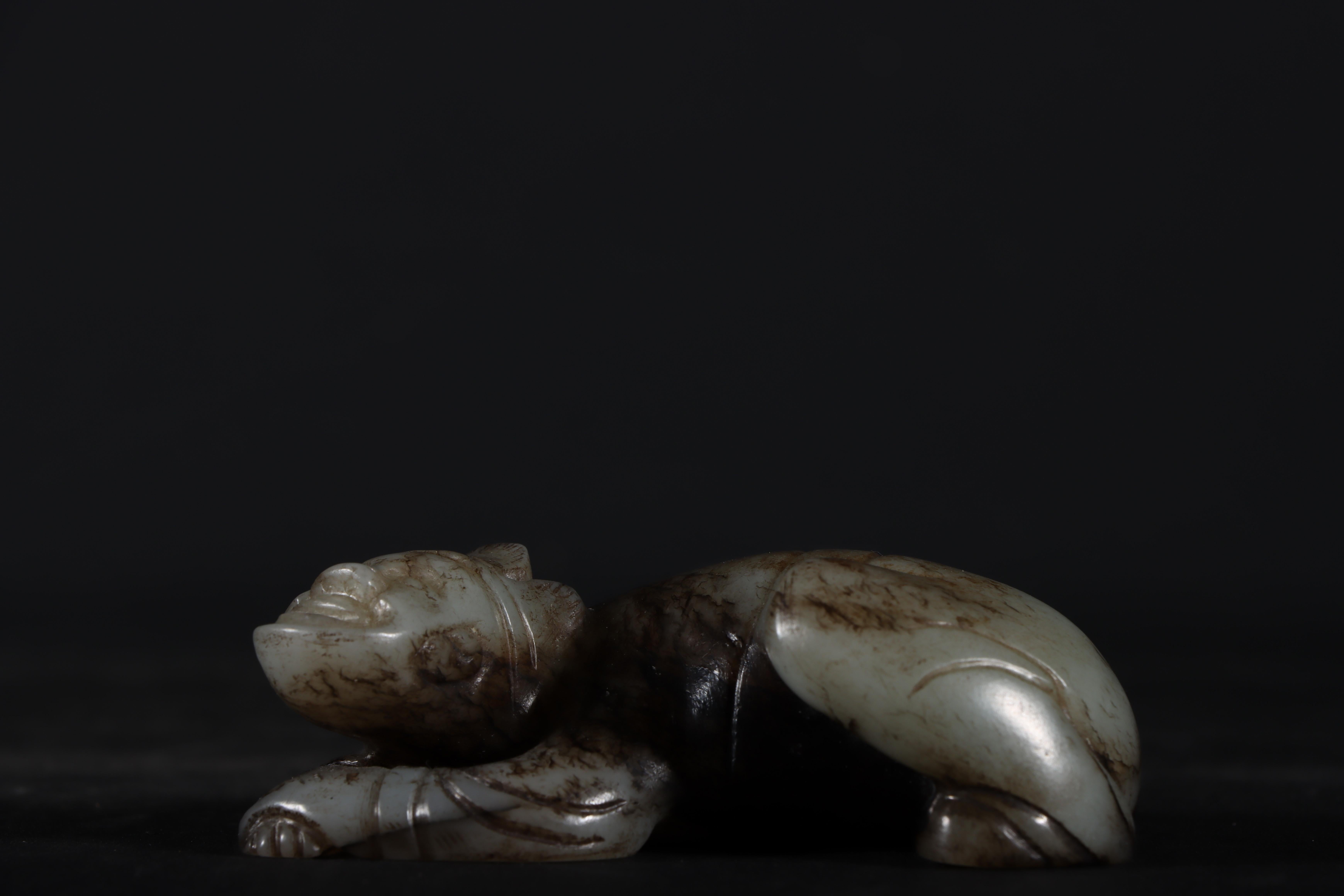 This antique jade sculpture showcases a beautifully hand-carved laying figure with an animal body, blending human and animistic features in a harmonious design. The intricate detailing and fine jade craftsmanship make it a unique and rare piece of