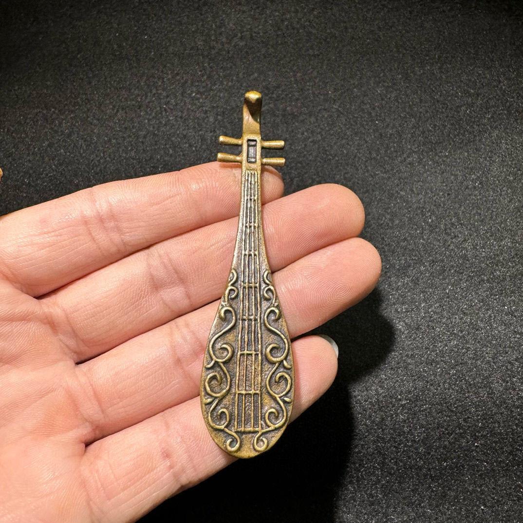 Step back into the rich musical traditions of ancient China with this Old Chinese Bronze Musical Instrument Pipa, a rare and exquisite artifact that symbolizes the artistry and cultural significance of traditional Chinese music. Crafted entirely