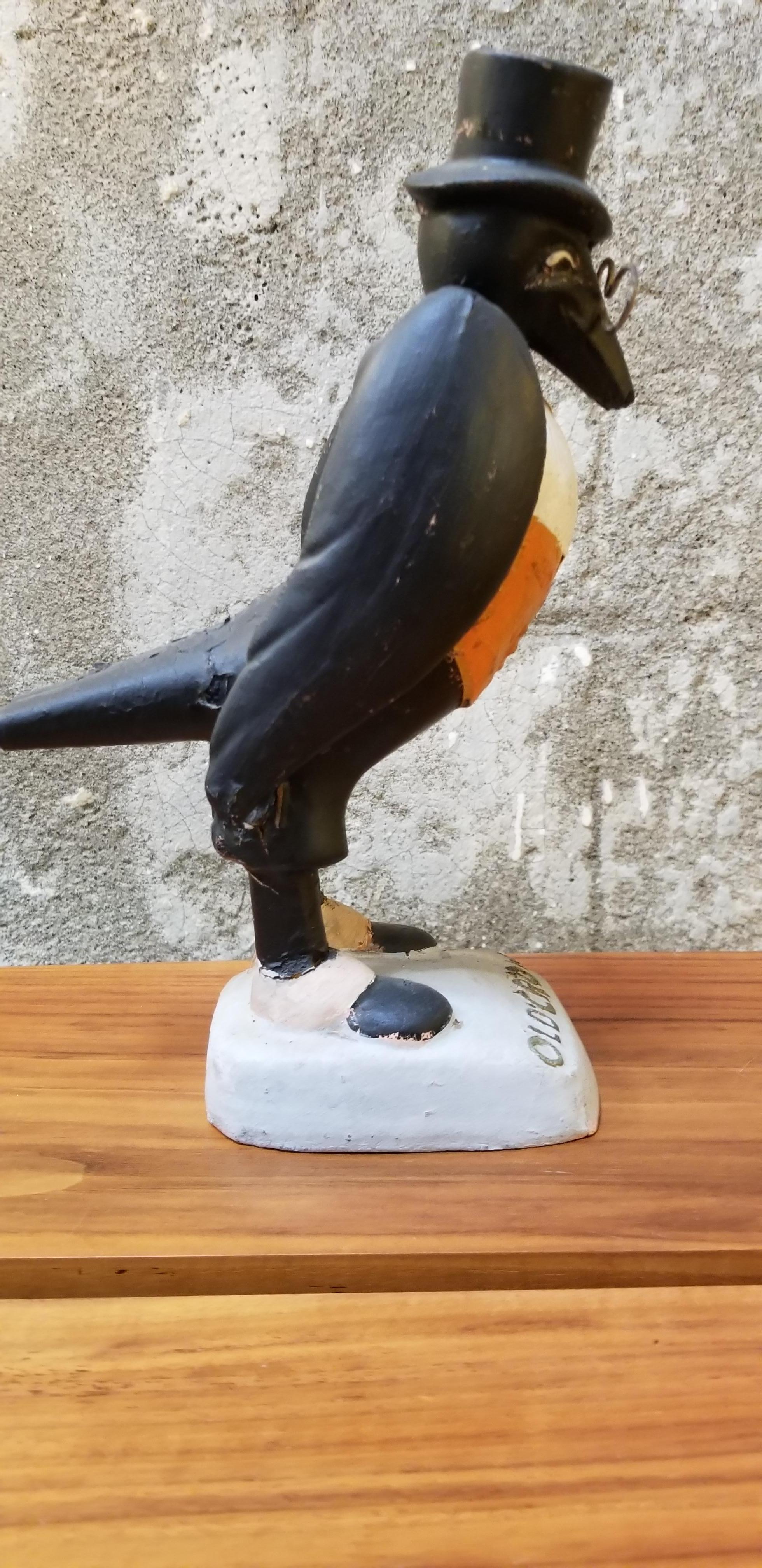 1940s bourbon whiskey advertising display figure of a crow with eyeglasses for Old Crow Whiskey. Good original condition. Retains makers label under base. Carbondale Toy & Novelty Company.