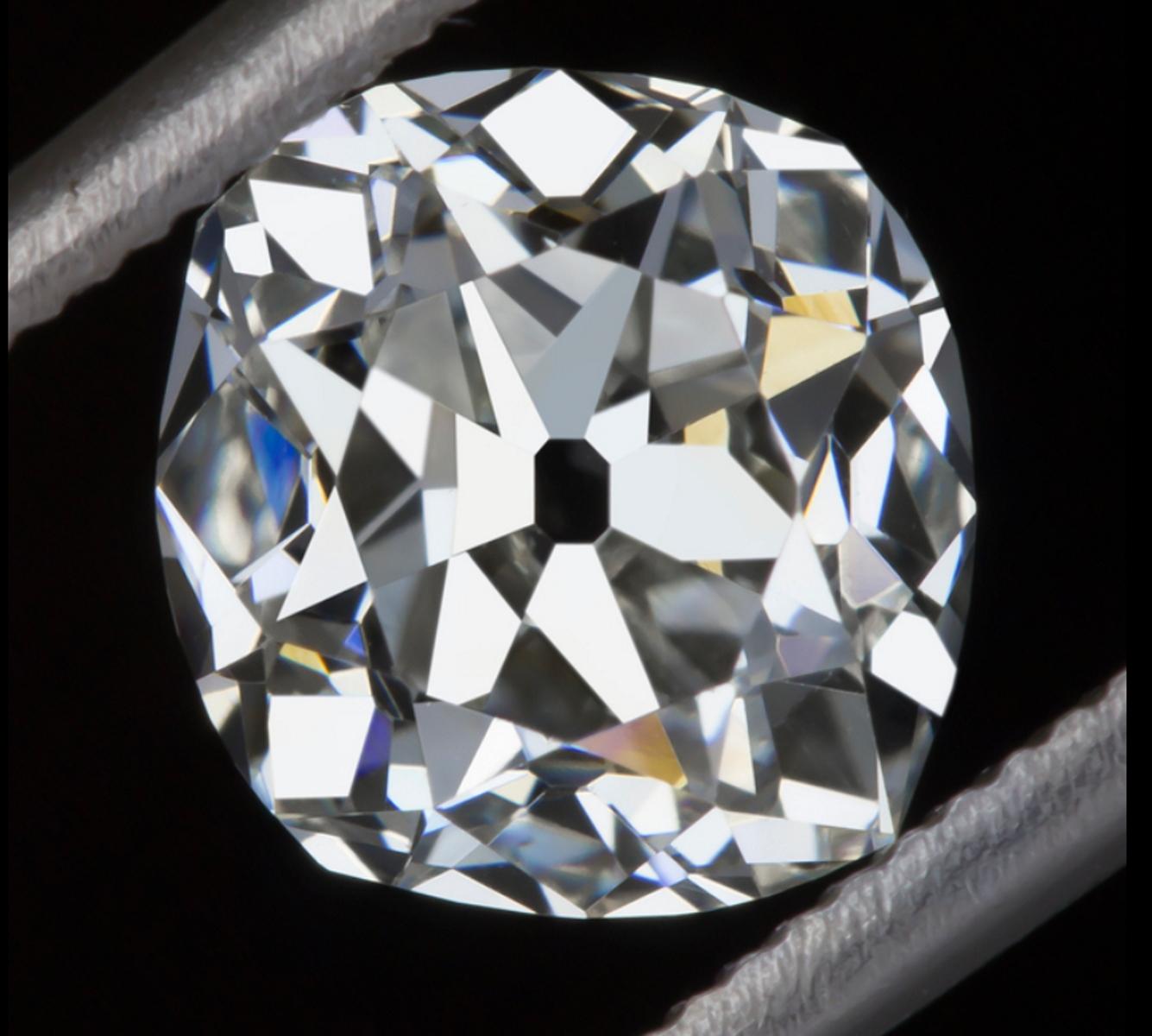 This 0.90 carat old mine cut diamond has charmingly wide hand cut facets! This high quality certified H Color and  si2 diamond is brilliantly white, a rare feature in old cut diamonds. The diamond has a charming square shape, and the unique cut has