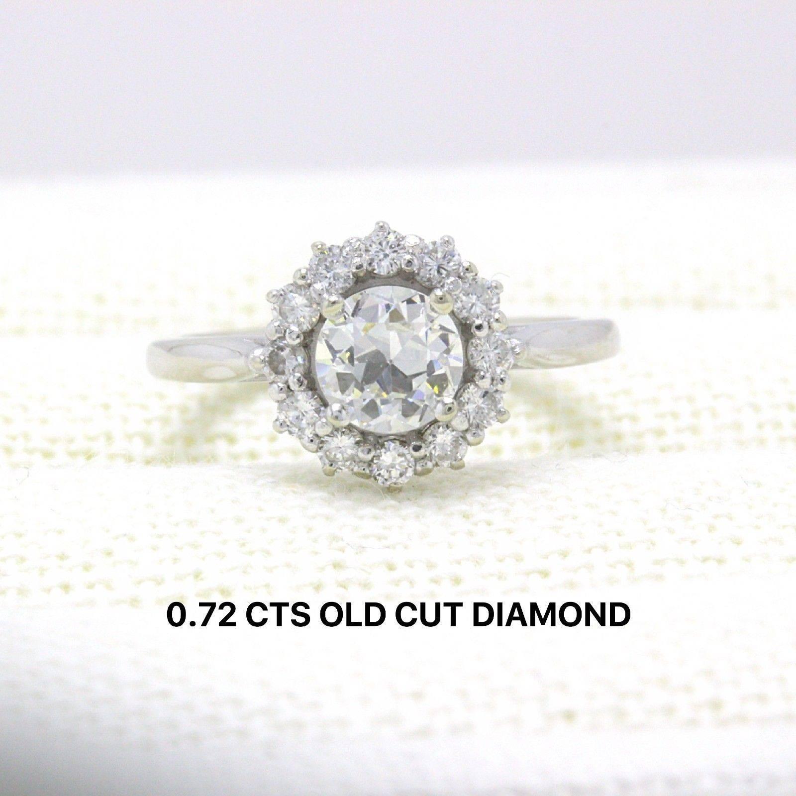 OLD CUT DIAMOND HALO ENGAGEMENT RING
Style: Halo
Metal: 18KT Yellow Gold
Size:   5.25 - Sizable
Total Carat Weight:  1.20 TCW
Diamond Shape:  Round Old Cut 0.72 CTS
Diamond Color & Clarity:   I / VS1 - VS2
Accent Diamonds:  12 Round Diamonds 0.48