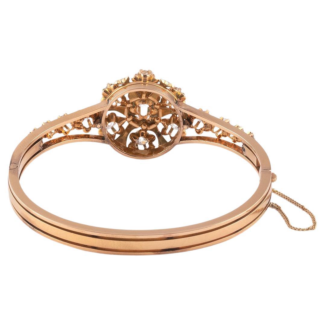 A diamond, enamel and 18K pink gold bangle, circa 1880. Gross weight : 27,45 gr. Flower diameter : 2,3 cm. Wrist diameter : 16,8 cm. 
Circa 1880's
