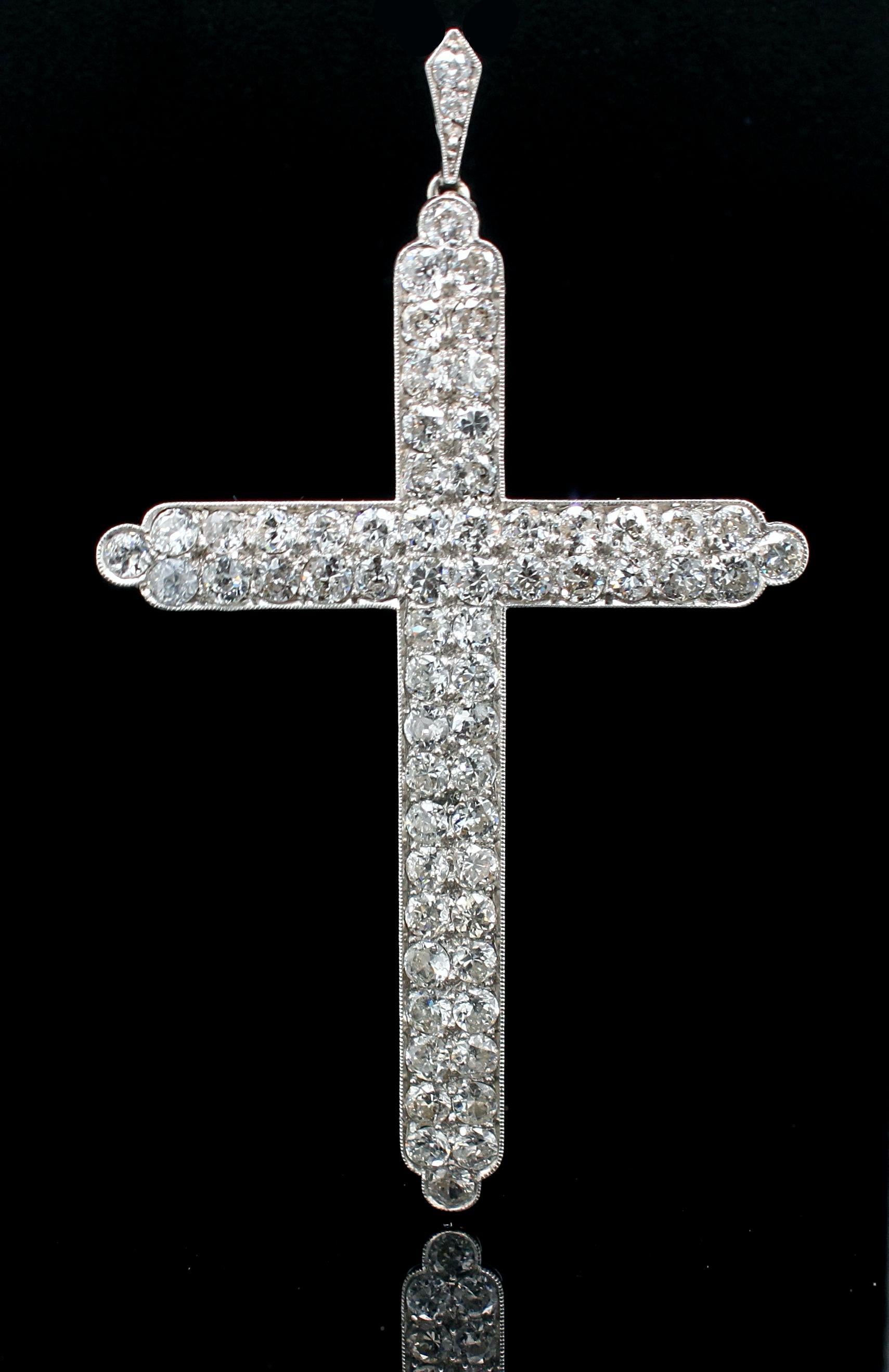 An old cut diamond cross pendant in platinum, ca. 1900s. 

The cross is set with 62 fine old cut diamonds weighing approximately 5 carats in total. The cross swings from a diamond set hoop to use this piece as a pendant. 

The pendant cross is 6.5