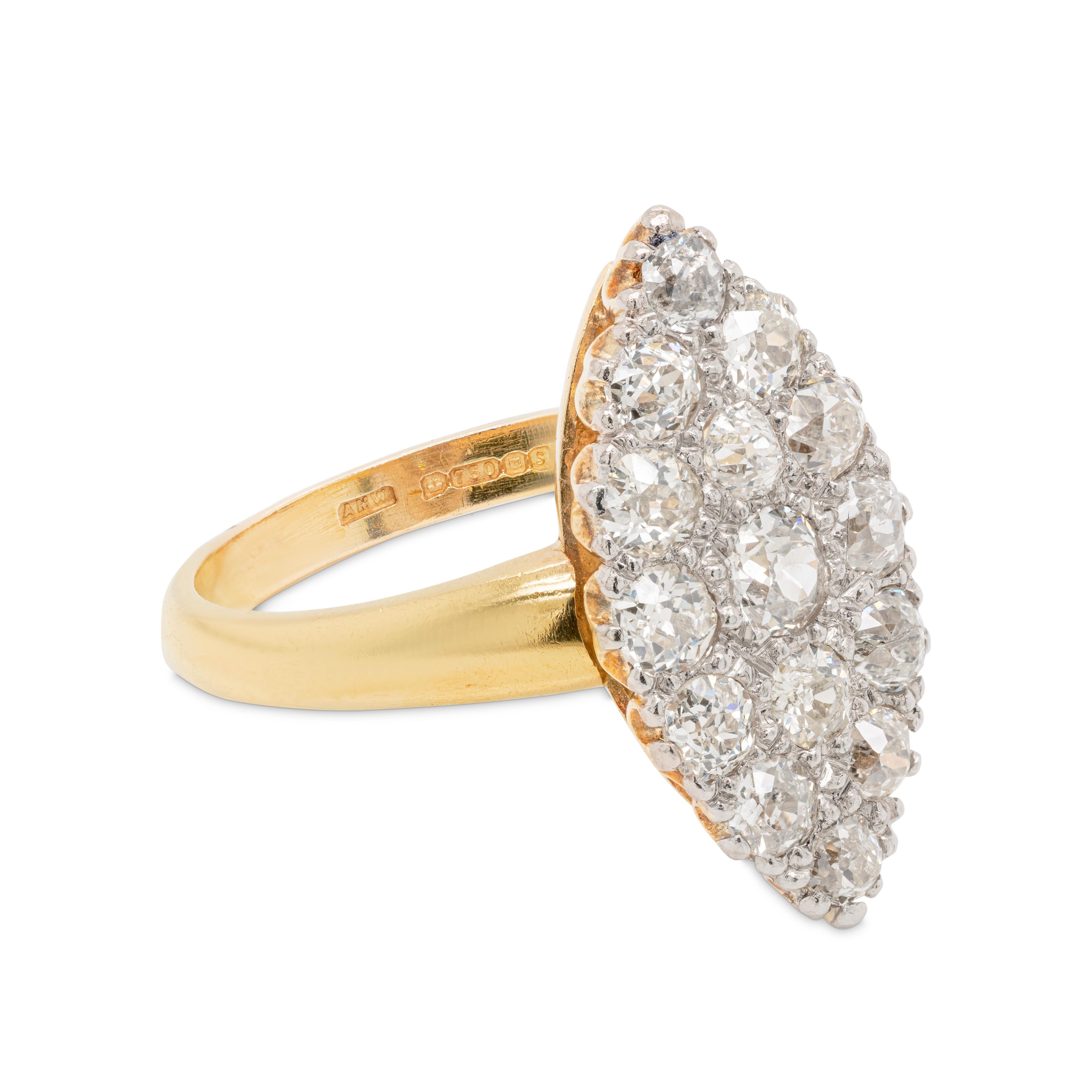 This gorgeous marquise shaped ring features a cluster of 15 Victorian old cut diamonds weighing a total approximate weight of 1.50ct, all pave set in 18 carat white gold. The beautiful cluster is set atop fine yellow gold shank . Hallmarked 1992,