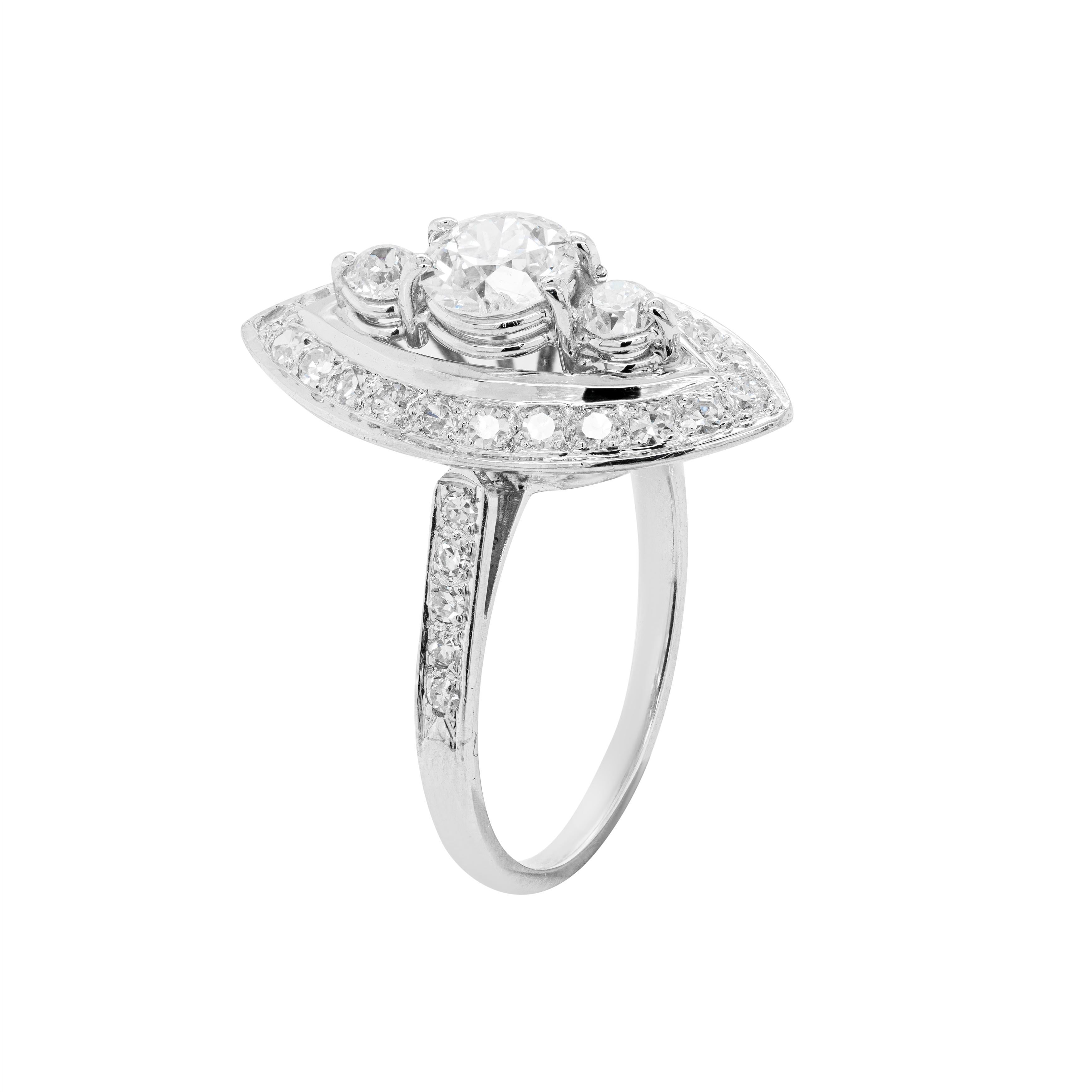 Marquise shaped dress ring featuring an old cut diamond weighing 0.87ct in the centre with two old cut diamonds vertically on either side with a combined weight of 0.30ct in open back claw settings.
The ring's border is grain set with 22 eight cut