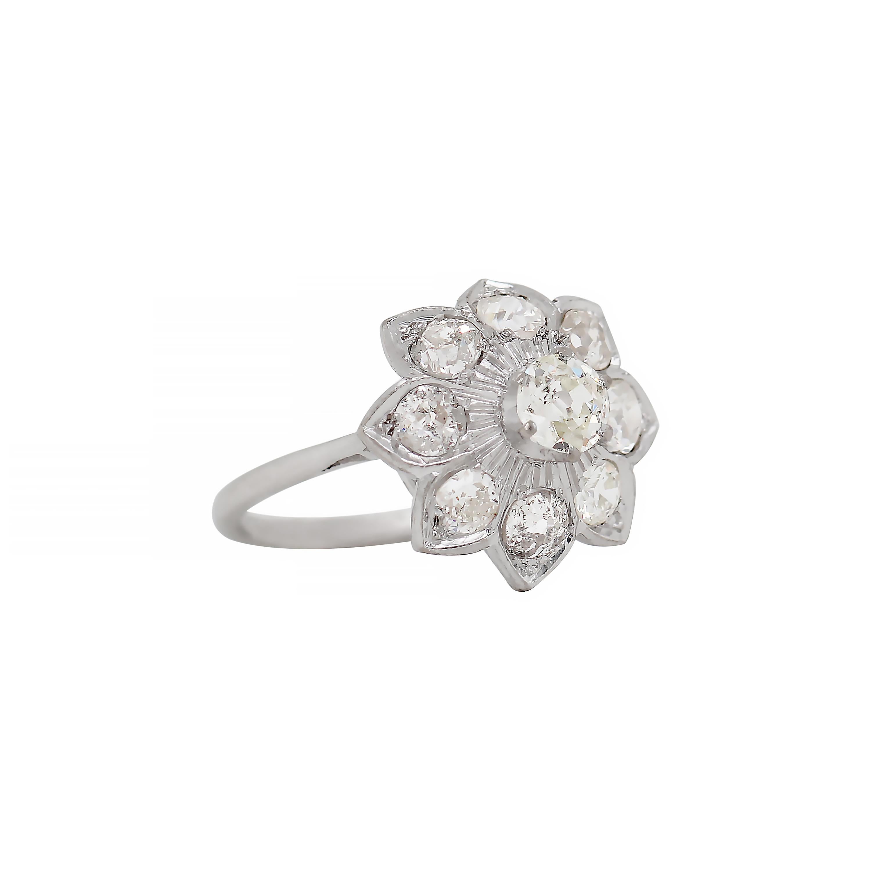 This one of a kind antique flower dress ring features a Victorian old cut diamond in the centre weighing approximately 0.30ct in a six claw open back setting. Surrounded are eight petals, each set with a Victorian old cut diamond all weighing an