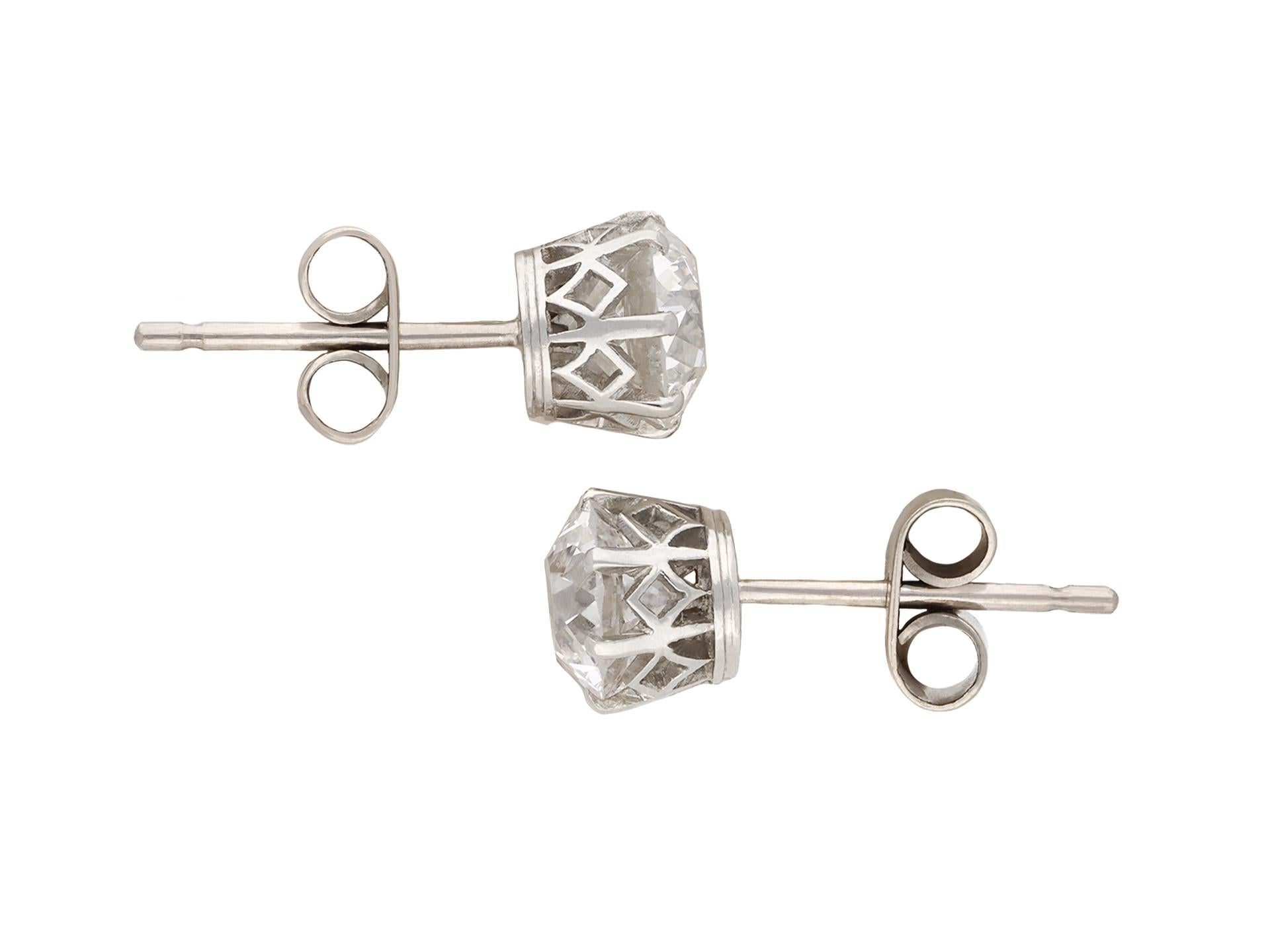 Old cut diamond stud earrings. A matching pair, each set with one round old cut diamond, one F colour, SI1 clarity, with a weight of 1.13 carats, the other G colour, SI1 clarity, with a weight of 1.18 carats, two in total in open back claw settings