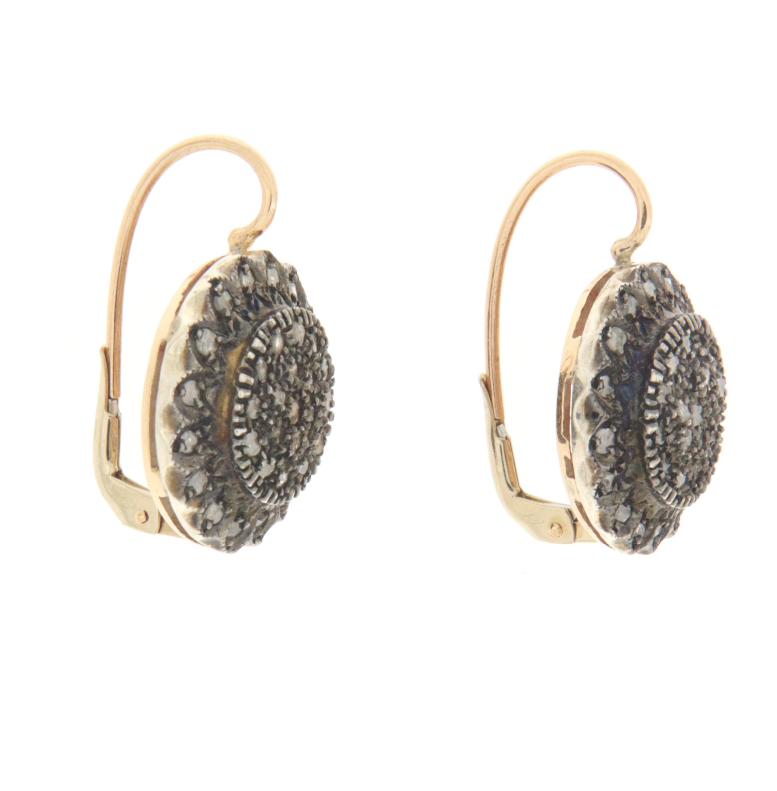 1950s
9 karat yellow gold and 800 thousandths silver stud earrings. Handmade by artisans assembled with old cut diamonds.

Earrings total weight 12.30 grams
Old Cut Diamonds weight 1.12 karat
(ring is not included in the price)