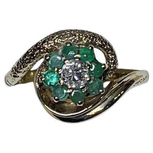 Old cut diamonds and green emerald antique engagement ring in 9ct yellow gold.