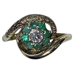 Old cut diamonds and green emerald antique engagement ring in 9ct yellow gold.