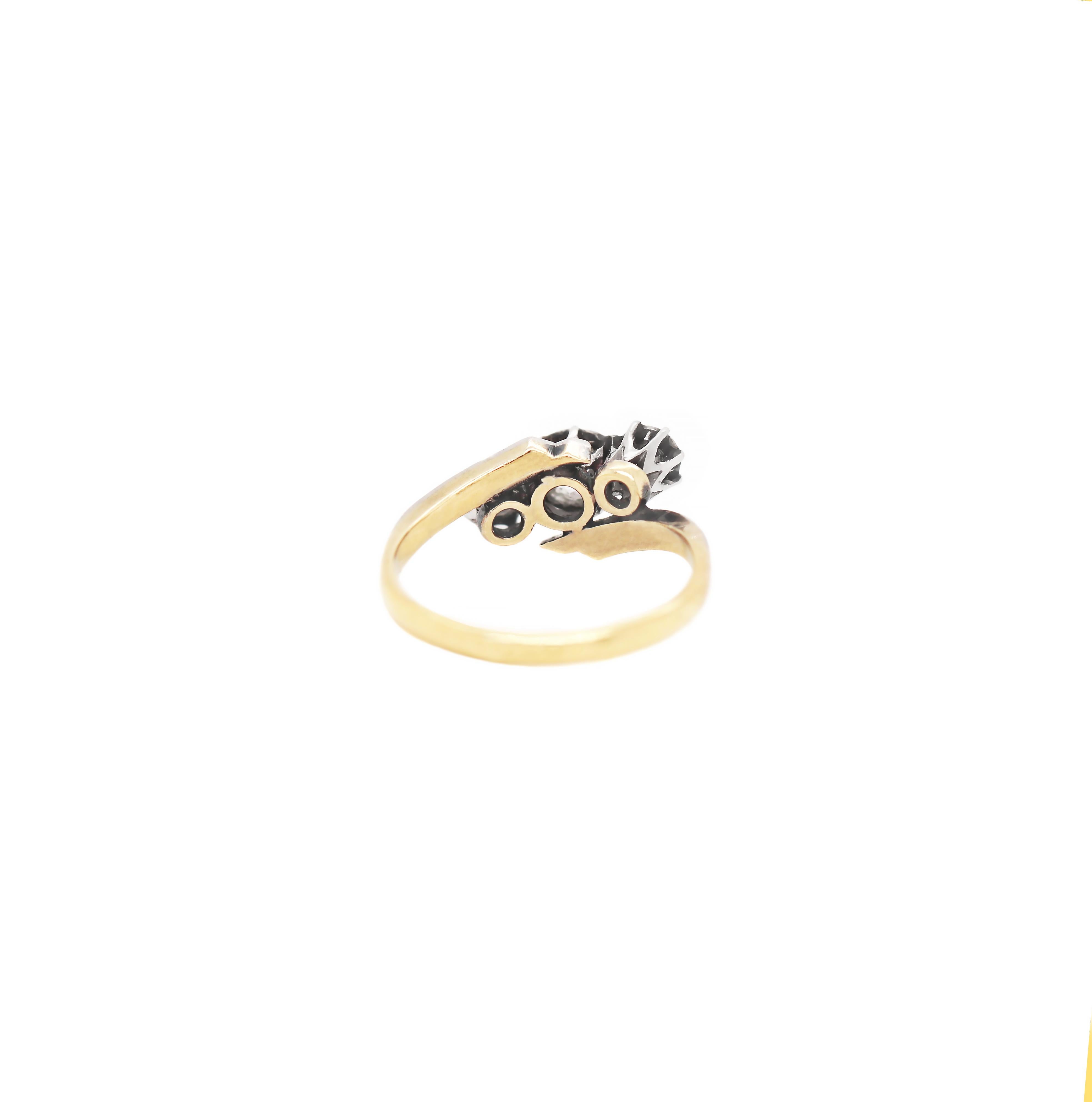Original antique twist engagement ring set with three old cut diamonds weighing approximately 0.70ct all in typical 1920's platinum illusion settings. The platinum twist is sat atop an 18 carat yellow gold shank stamped 18CT PLAT. UK finger size 'N'.