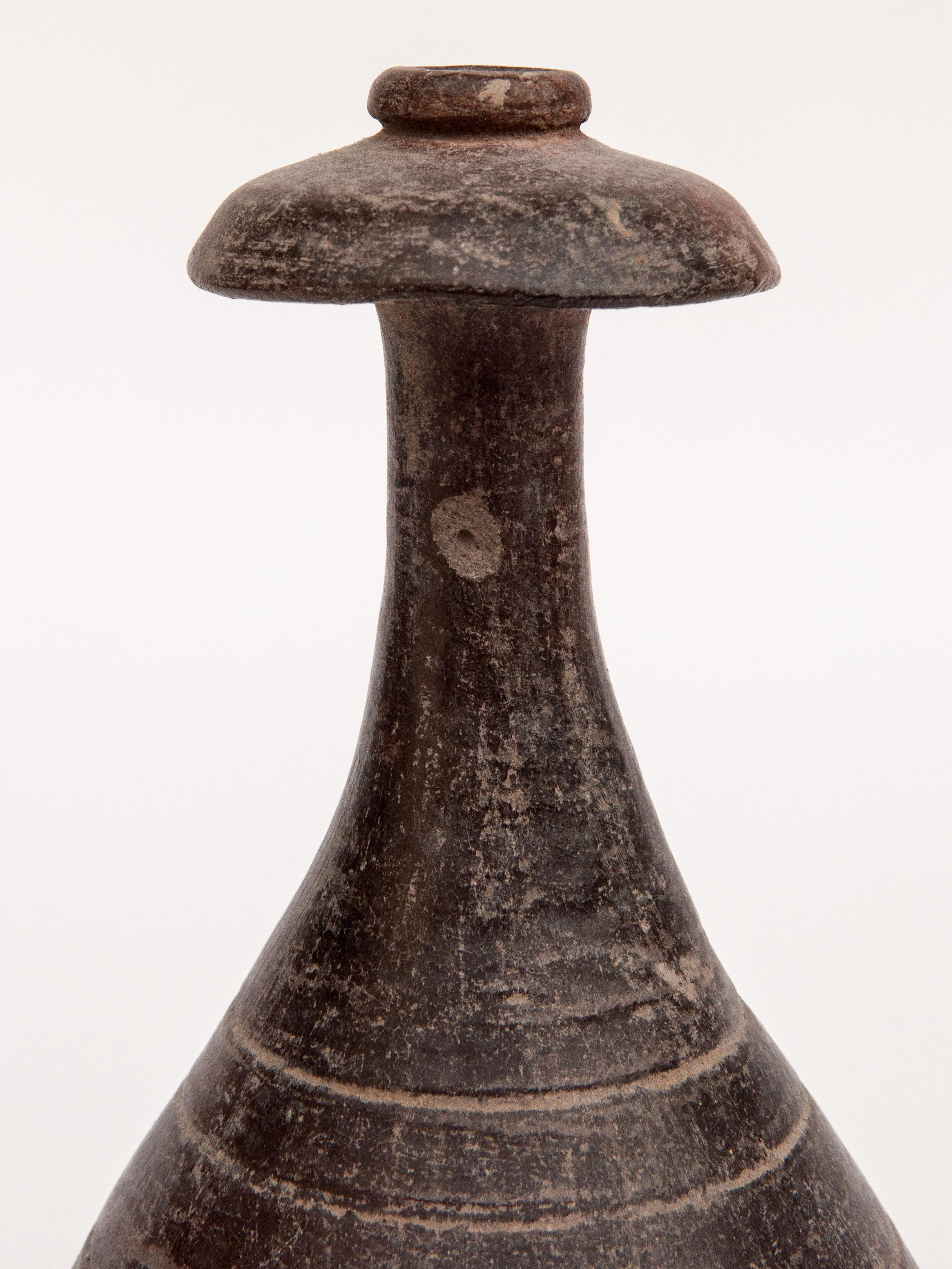 Old Unglazed Earthenware Kendi. Majapahit style. North or East Java, late 19th century.
Kendi are pouring and drinking vessels found throughout Southeast Asia since ancient times, and were used in day to day life, as well as for ritual purposes. The
