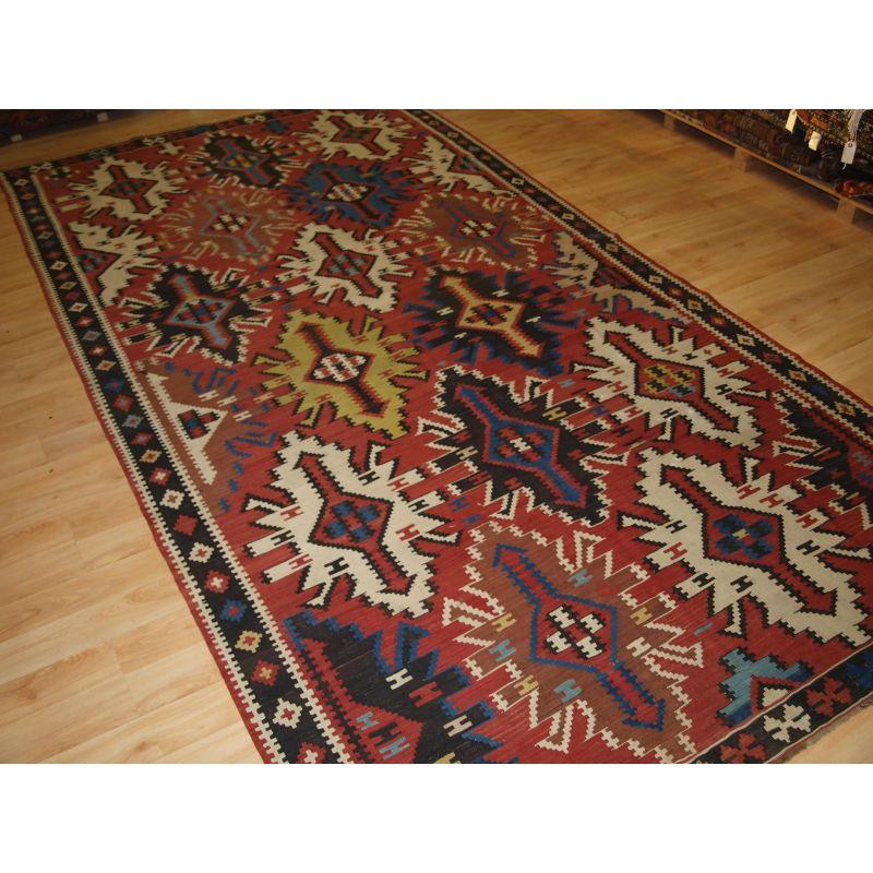 Old East Caucasian Avar kilim of outstanding colour and design.

A good example of a traditional Avar kilim from Daghestan in the Eastern Caucasus. The soft red ground off sets the bold 'racing car' design well. A colourful but striking old