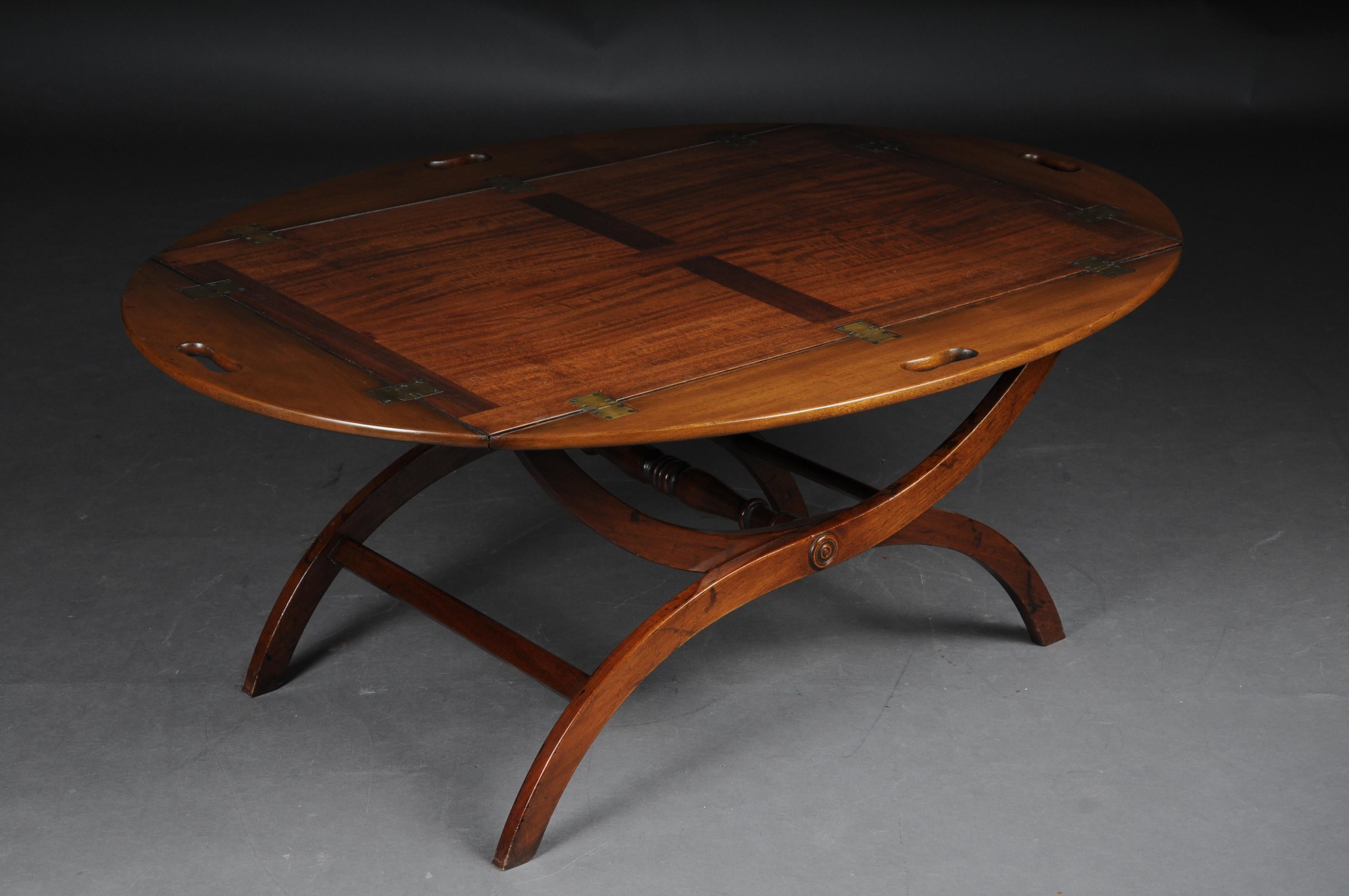 Old English captain's table / coffee table / butler's tray, mahogany

Solid mahogany table with brass fittings. Tabletop on scissor-shaped frame connected with center bar. Very high quality processed. Perfect as a coffee table. England 20th