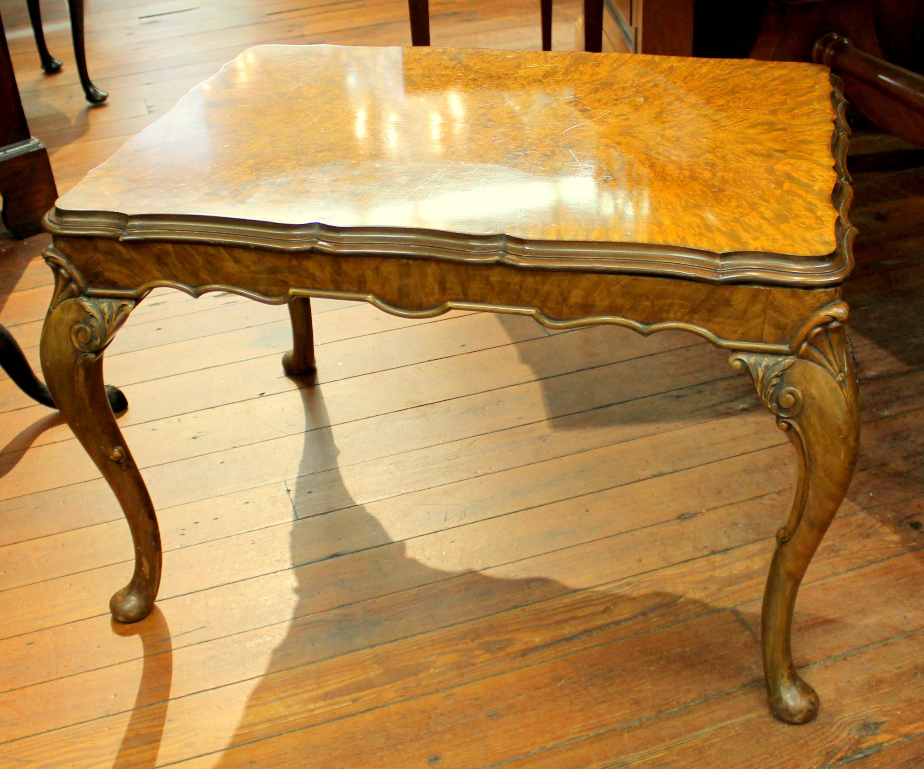 Fine old English burr walnut Georgian style carved coffee table with exquisite, highly figured book matched burr walnut. (Some old scratches noted and illustrated). Exceptional hand-carved cabriole legs. Wonderfully useful size.
 