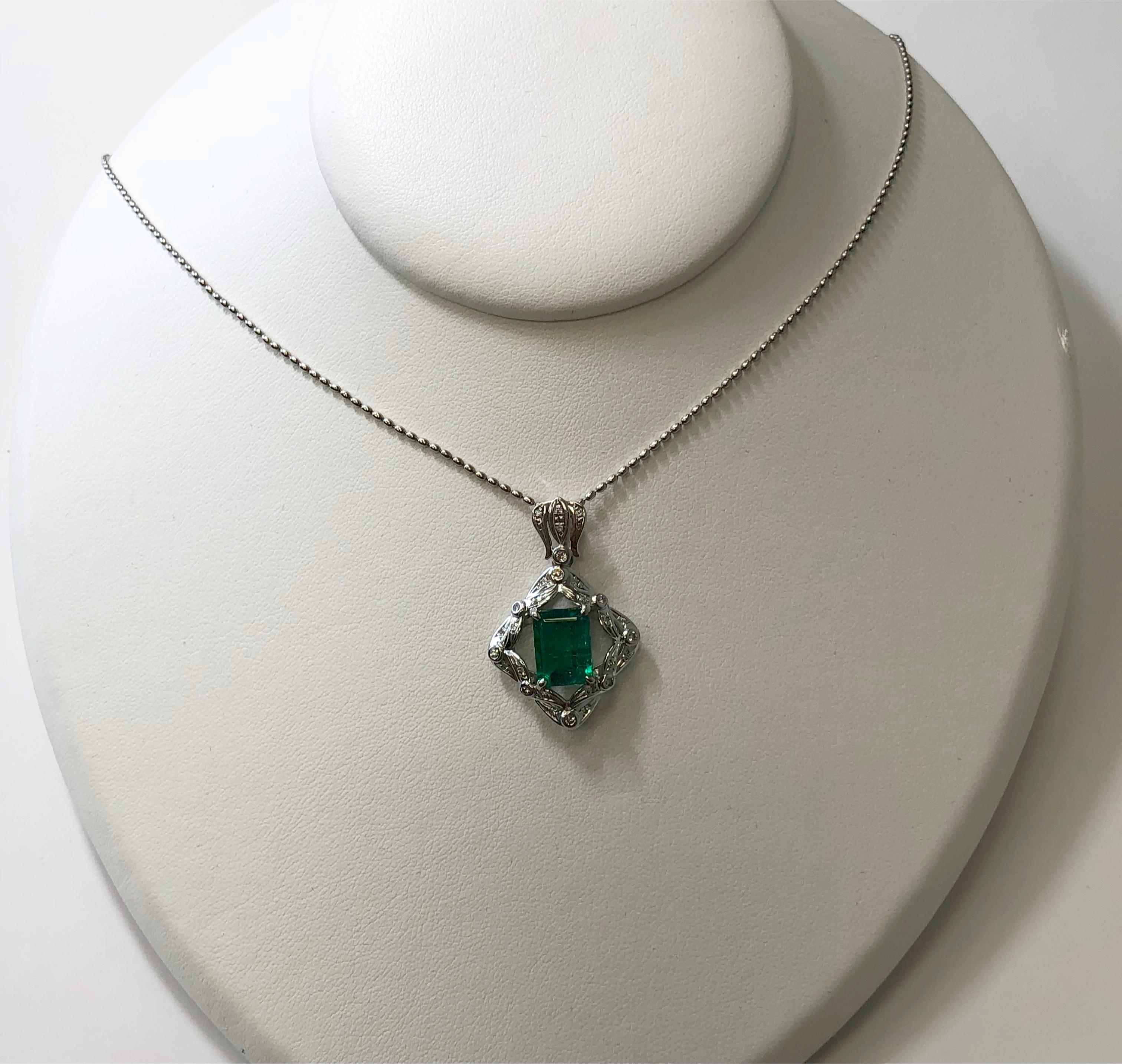 This beautiful Old English inspired emerald and diamond necklace has a 3.05 ct emerald cut emerald with a rich green crystal and gorgeous luster.  The diamond weight is 0.27 ct on an 18 inch chain.  Perfect for everyday or a special occasion!