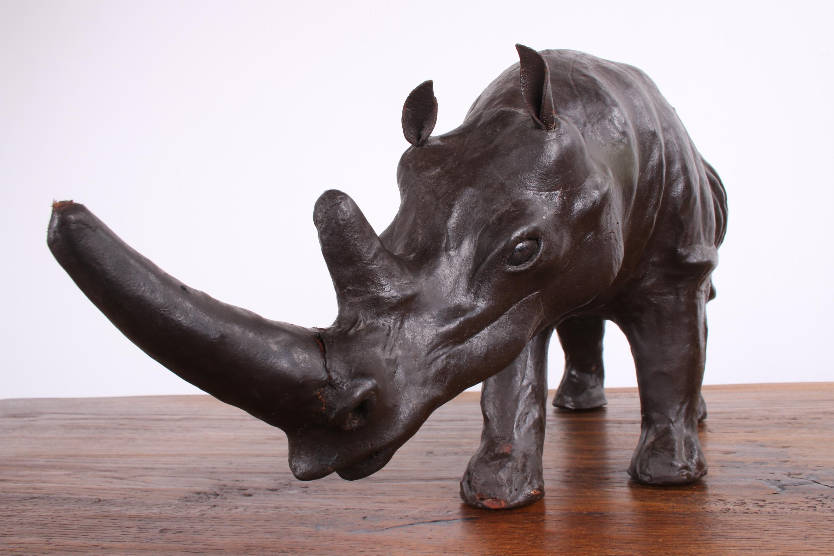 This is a rhino made in England sometime in the 1950's.

The rhinoceros is covered with real leather, presumably bovine leather, beautiful brown in color.

This is a nice item to put somewhere.

This rhinoceros is in good condition.


   