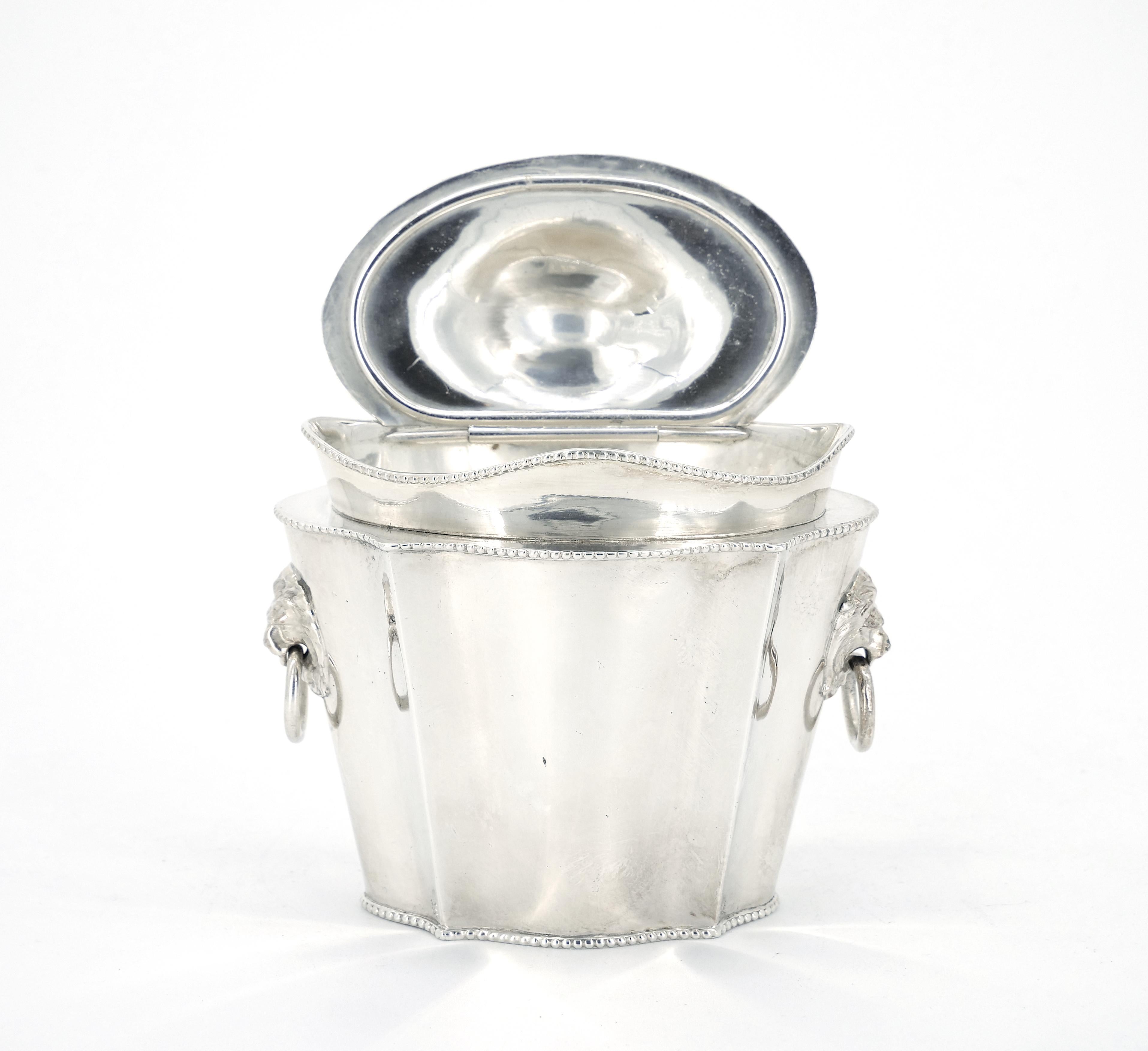 
Experience the timeless allure of our Old English Sheffield silver plate art deco style tea caddy, adorned with captivating lion head side handles and an attached cover. This extraordinary piece is a testament to the exquisite craftsmanship of a