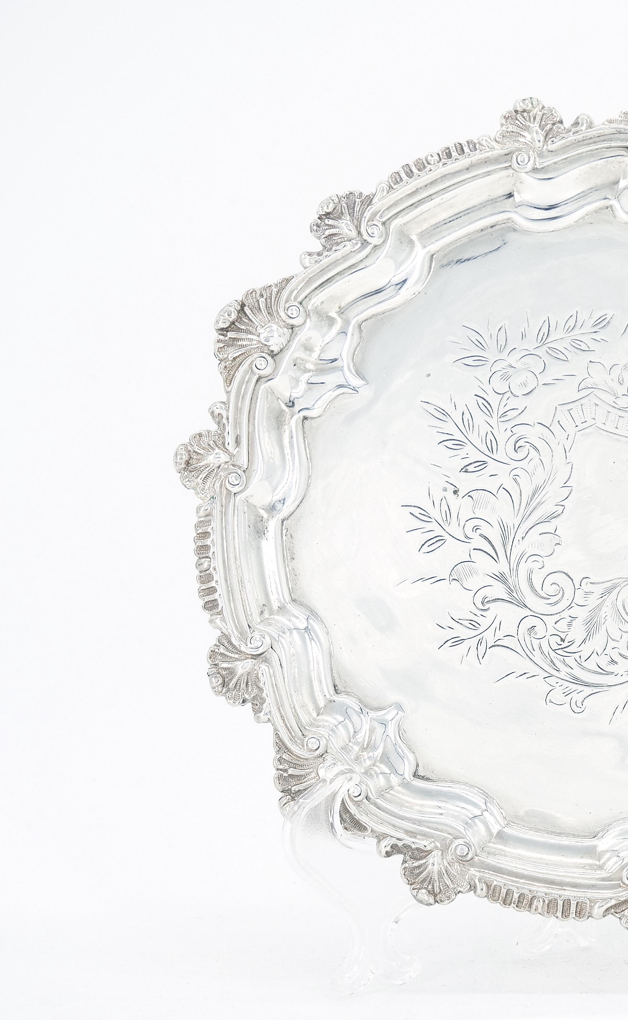 
Introducing this captivating Old English Sheffield small silver plate footed tray, featuring an intricately hand- engraved interior and a graceful round shape. This exquisite piece showcase the artistry of yesteryears, combining timeless elegance