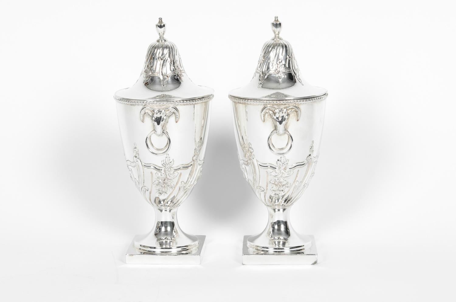Old English Sheffield silver plate / copper pair of covered urns or vases. Each vase / urn is in excellent antique condition. Each one measure about 8.5 inches high x 4 inches diameter. Base is 2.5 inches x 2.5 inches.