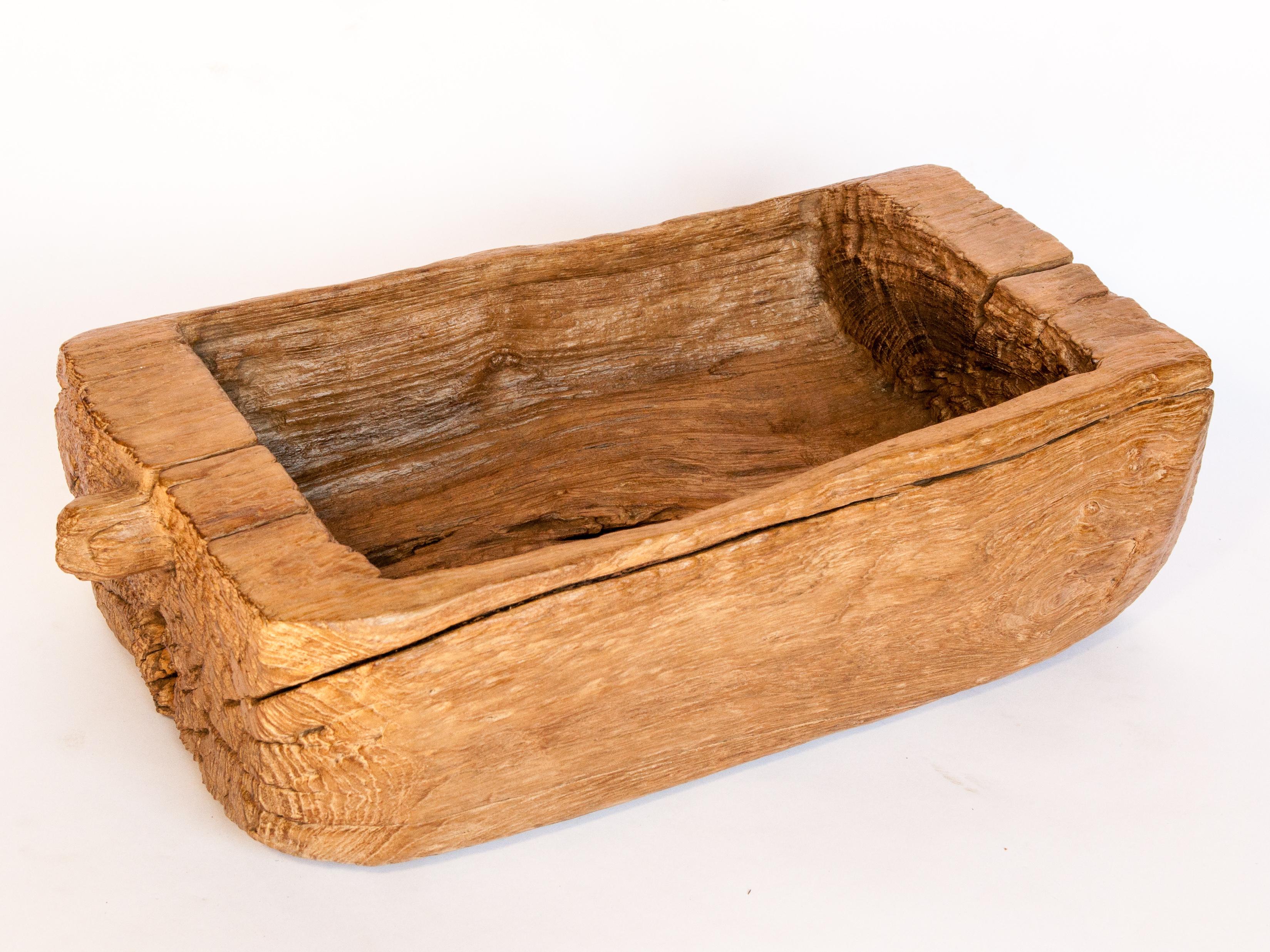 An old eroded teak trough or planter. From North Thailand, mid-20th century.
This rustic teak trough makes for a beautiful tabletop or garden planter. It comes from a rural household in North Thailand where it was fashioned by hand using simple
