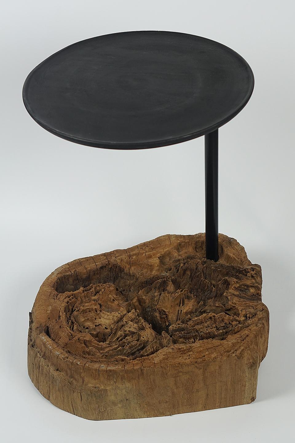 End table old erroded wood with an iron stick, a table top made of mango wood
Inhouse production (Designer Cocomaster).

Beautiful organic eroded wood, with a mango wood plate on an iron stick. 
The foot was made of old eroded wood.