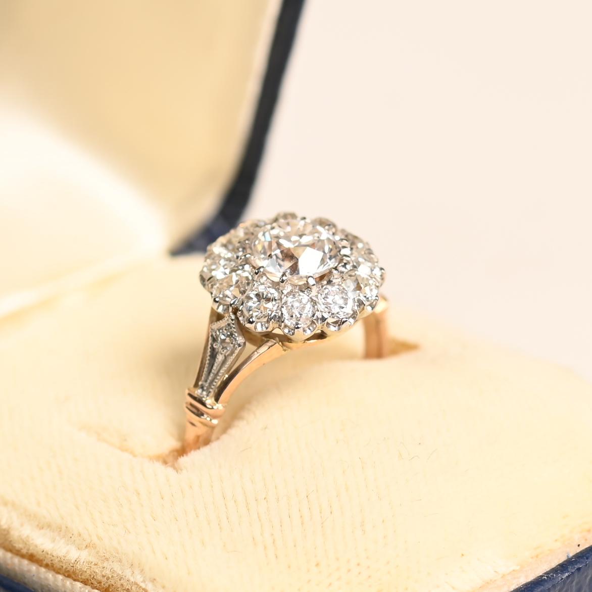 Presenting an exquisite vintage-inspired cluster diamond engagement ring, masterfully crafted to capture timeless elegance. At its heart lies a mesmerizing approx. 0.90-carat old European cut diamond, prized for its rich character and romantic glow.