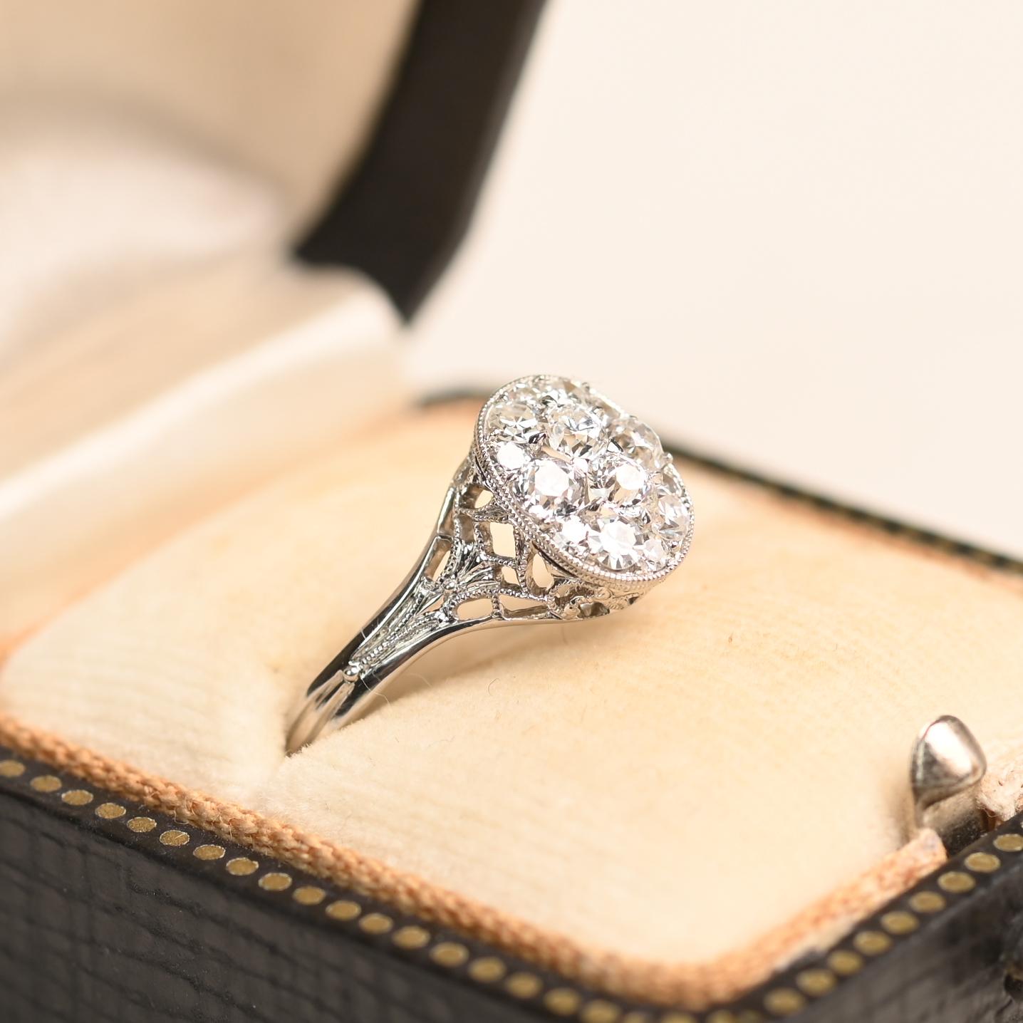 This elegant ring features a cluster of Old European cut diamonds, set in shared prongs within an oval-shaped bezel. The diamonds have a combined weight of approximately 0.30 carats, with an overall I color and VS2 clarity. Handcrafted in platinum,
