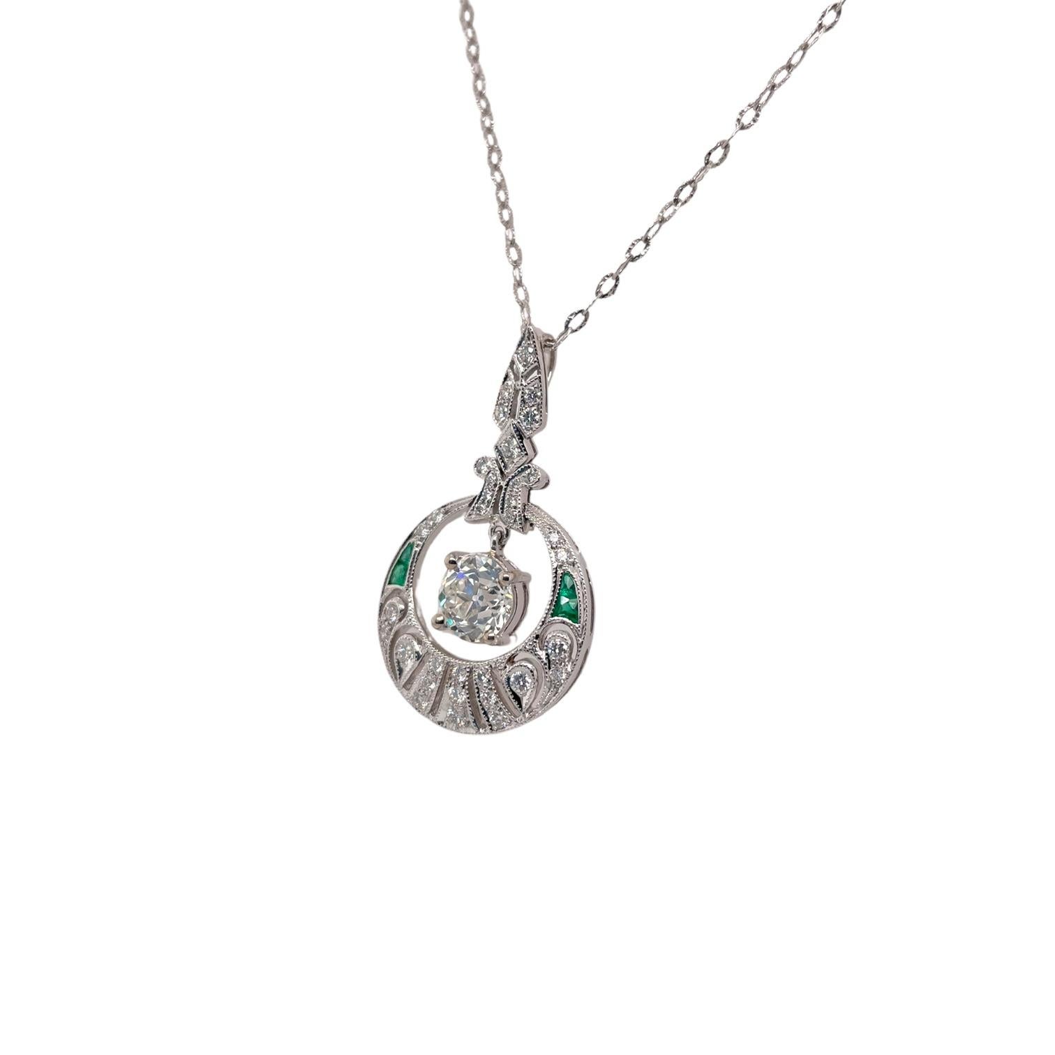 Pendant contains 1 center Old European cut diamond, 1.04ct. Diamond is set in a basket setting and hangs within an Art Deco style pendant containing 33 round brilliant diamonds, 0.35tcw and 4 fancy shape emeralds, 0.30tcw. Based on our opinion,